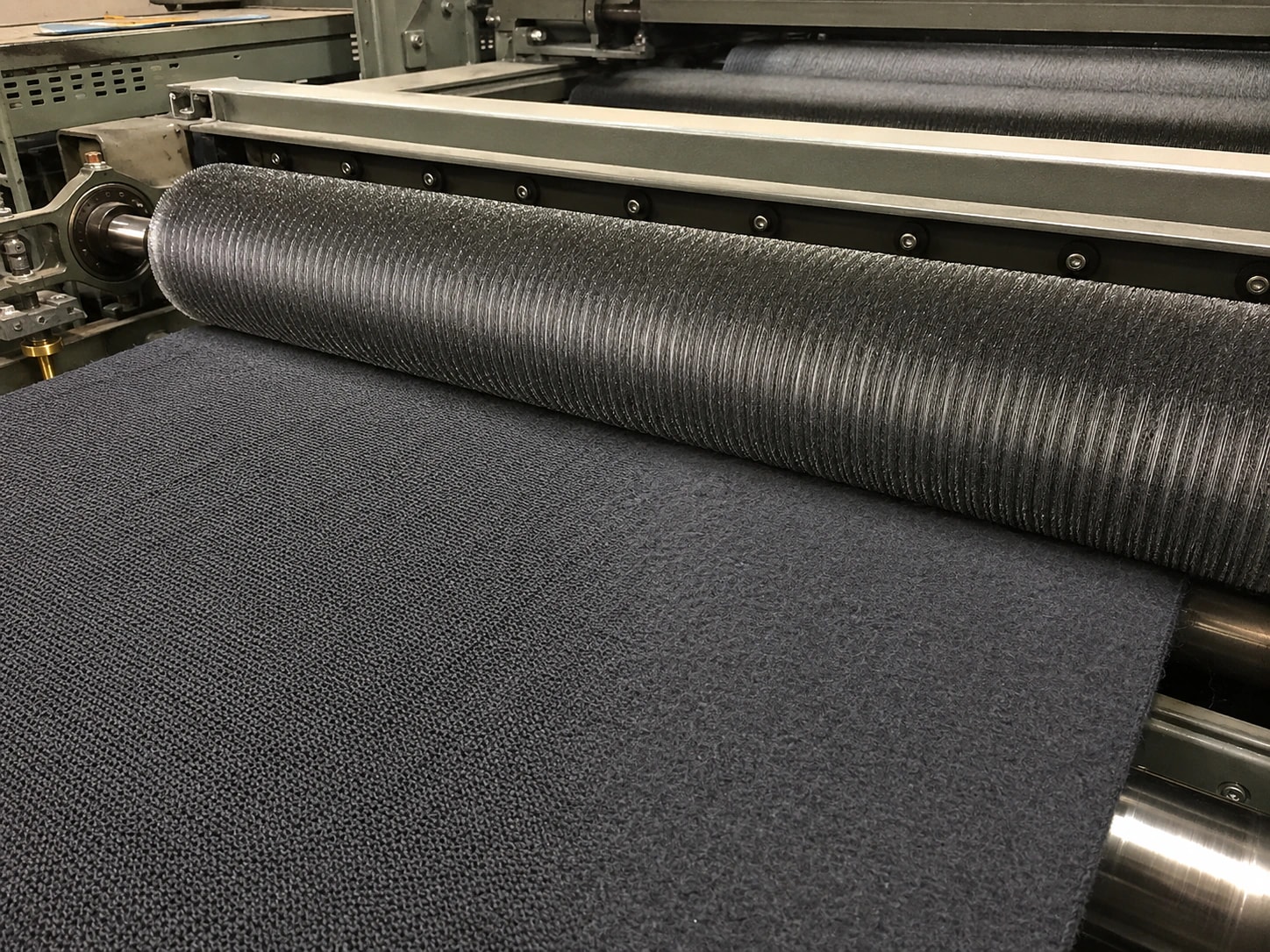 Illustration of a raising machine brushing loopback sweatshirt fabric into fleece
