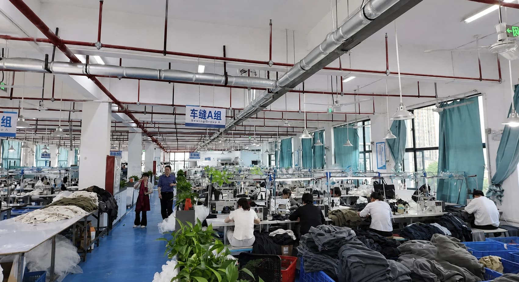 KAOUYOU Ganzhou production workshop with active sewing stations and menswear production