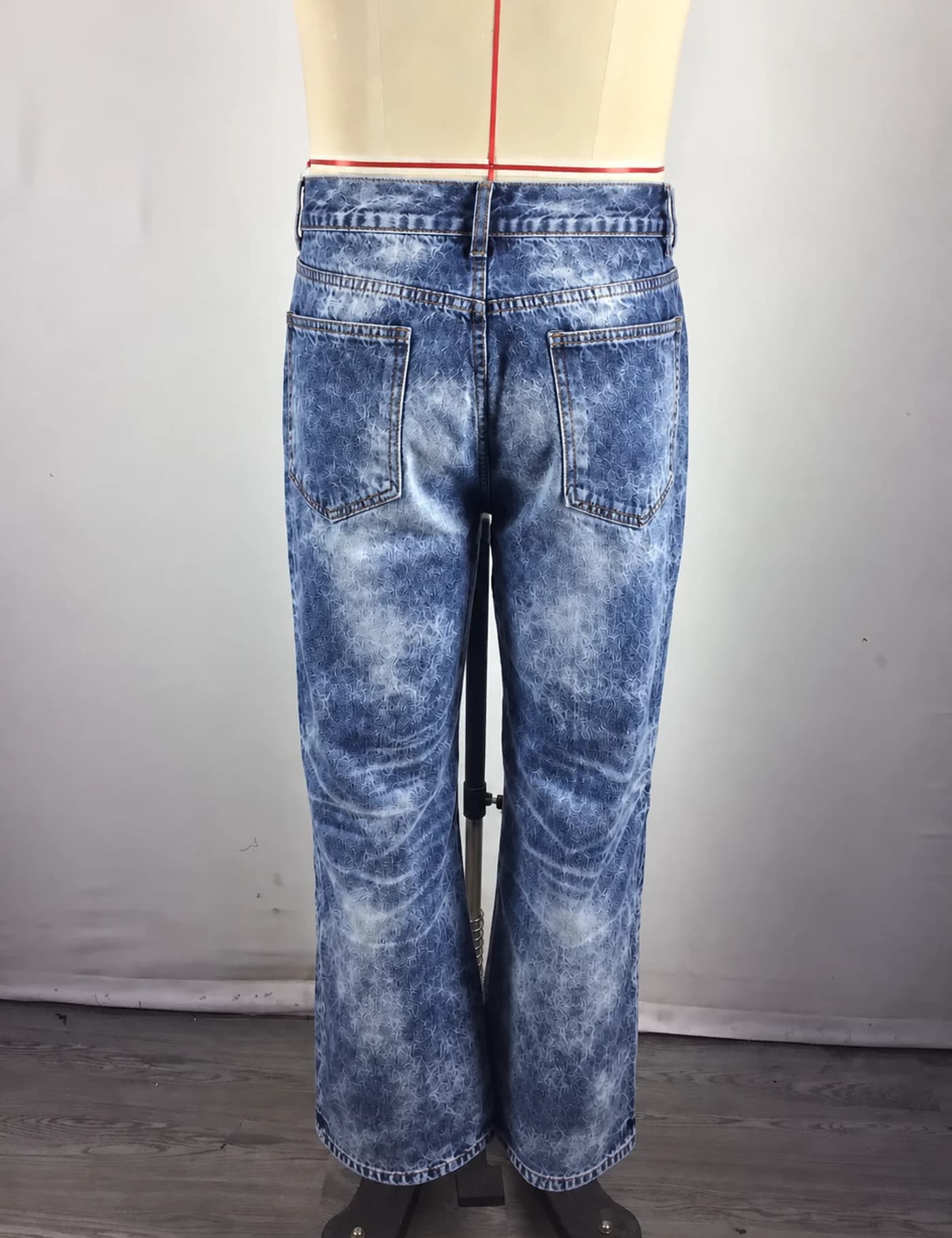 Actual acid-wash wide-leg jeans sample shown from the back on a mannequin