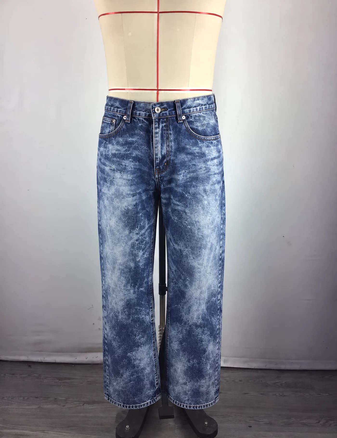 Actual acid-wash wide-leg jeans sample shown from the front on a mannequin