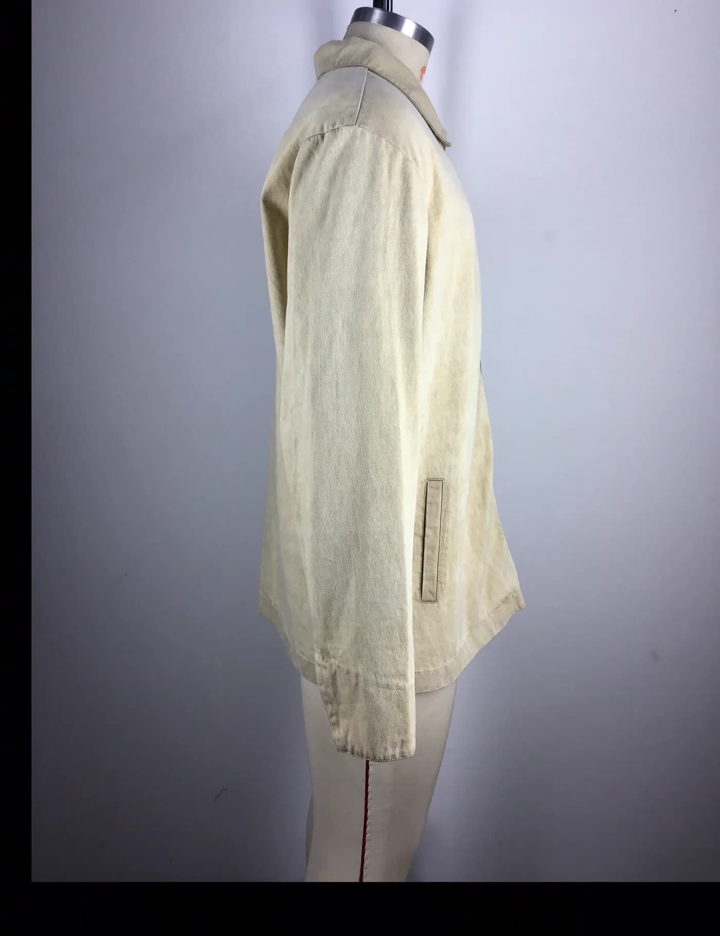 Actual beige washed zip coach jacket sample shown from the side on a mannequin