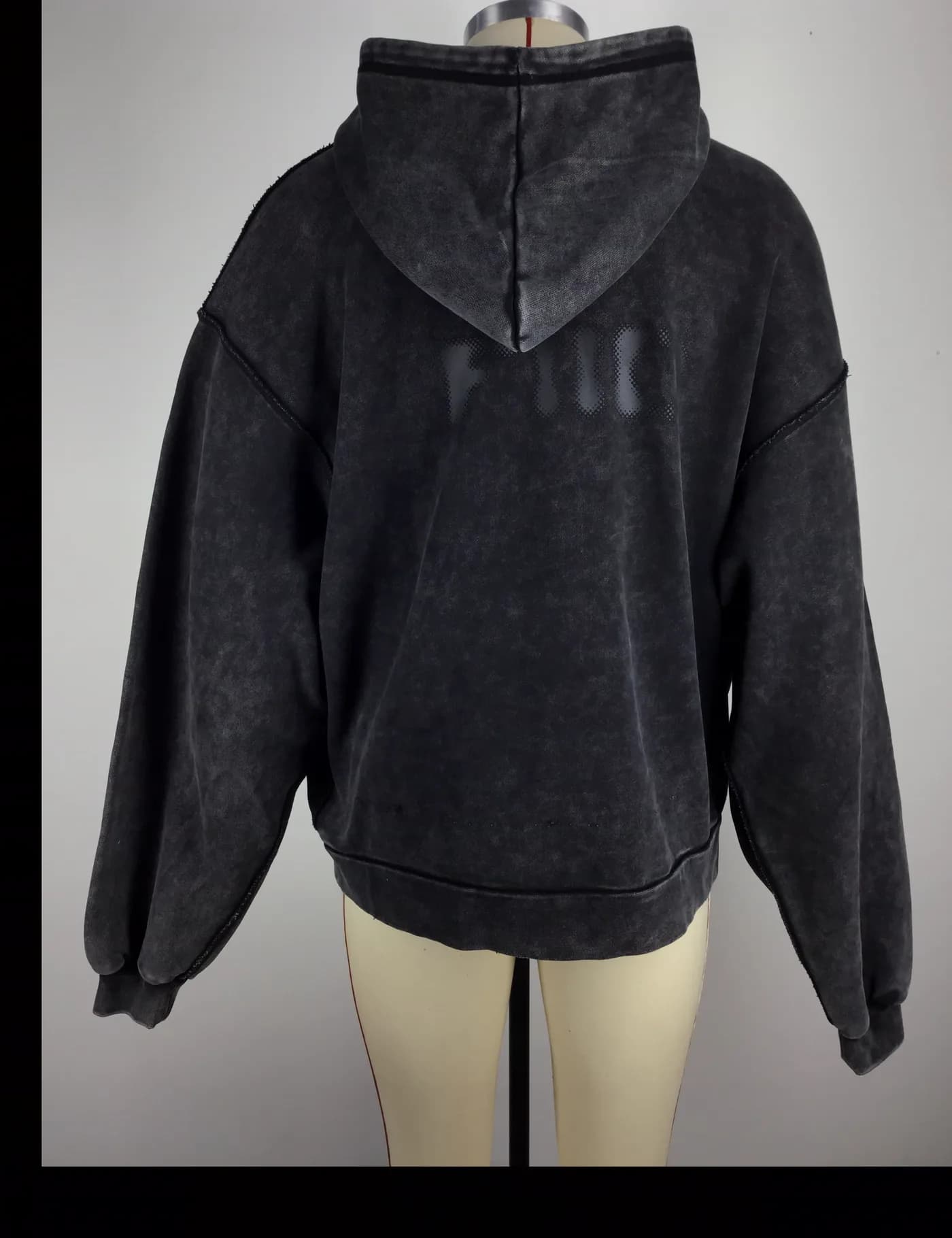 Actual black acid-wash pullover hoodie sample shown from the back on a mannequin