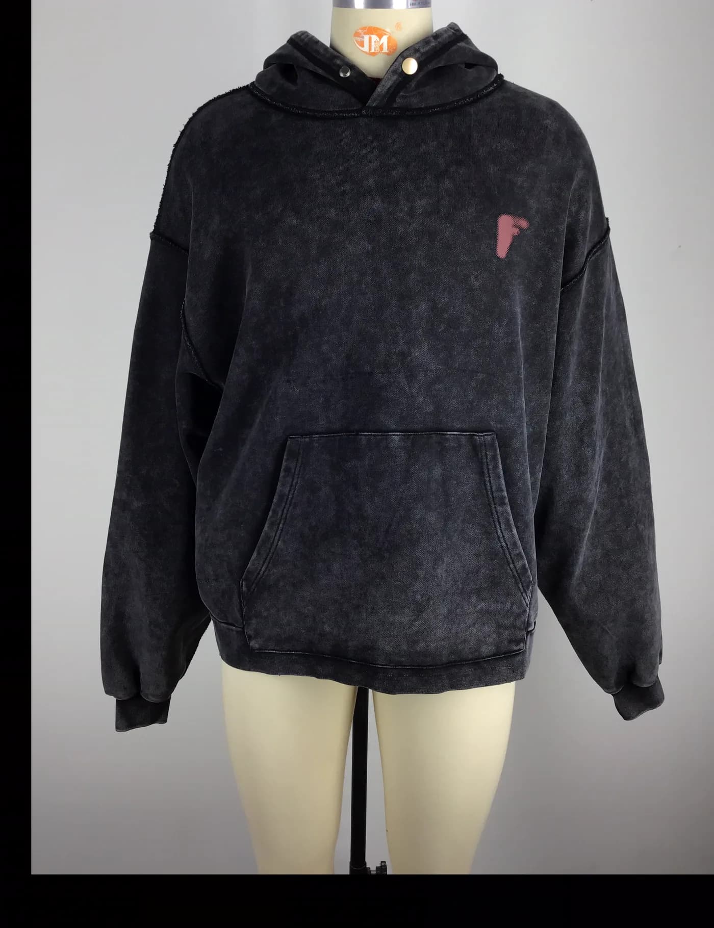 Actual black acid-wash pullover hoodie sample shown from the front on a mannequin