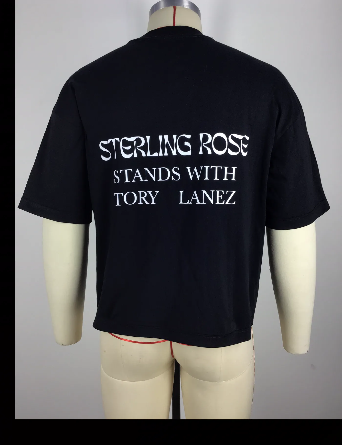 Actual black boxy fit graphic t-shirt sample shown from the back on a mannequin