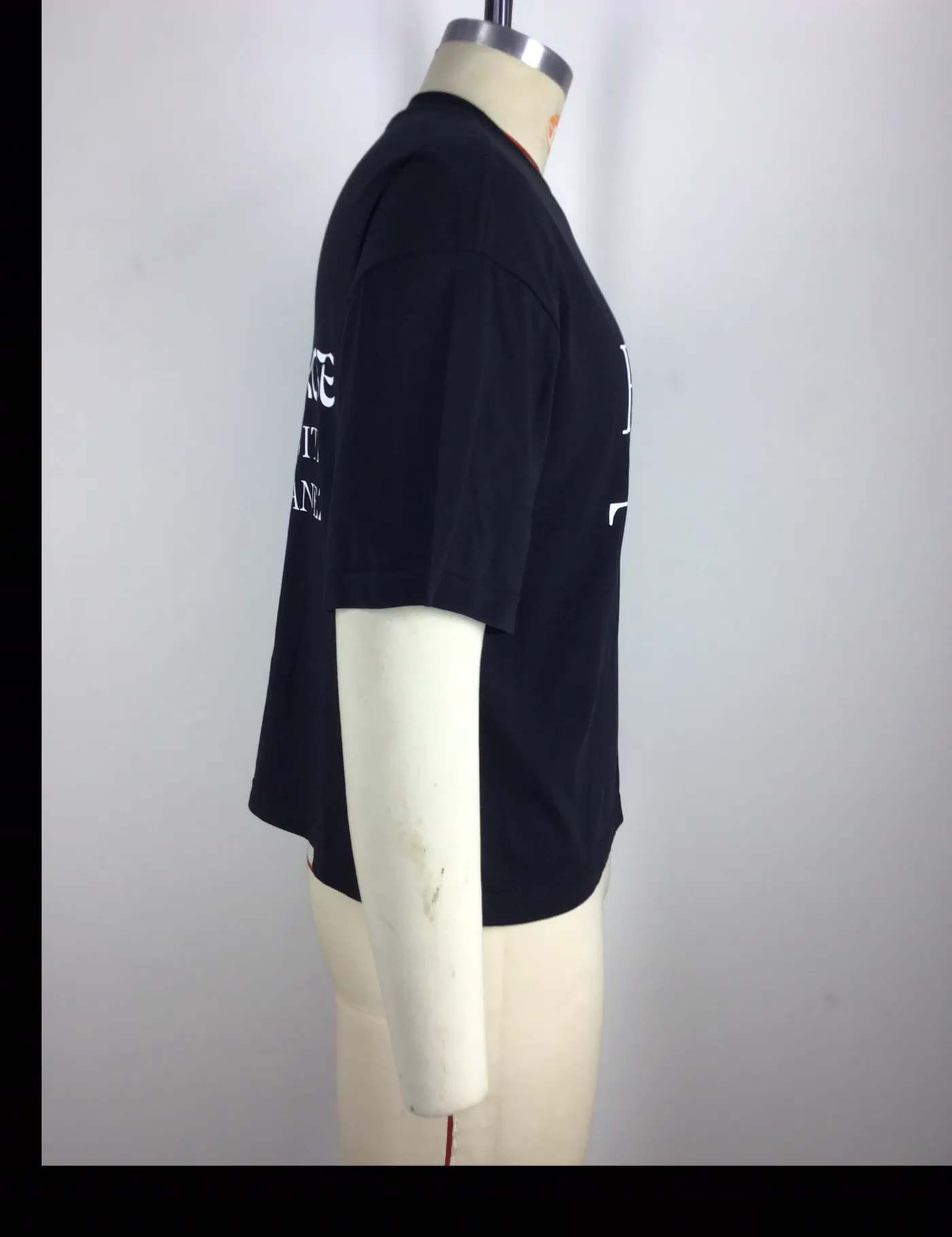 Actual black boxy fit graphic t-shirt sample shown from the side on a mannequin
