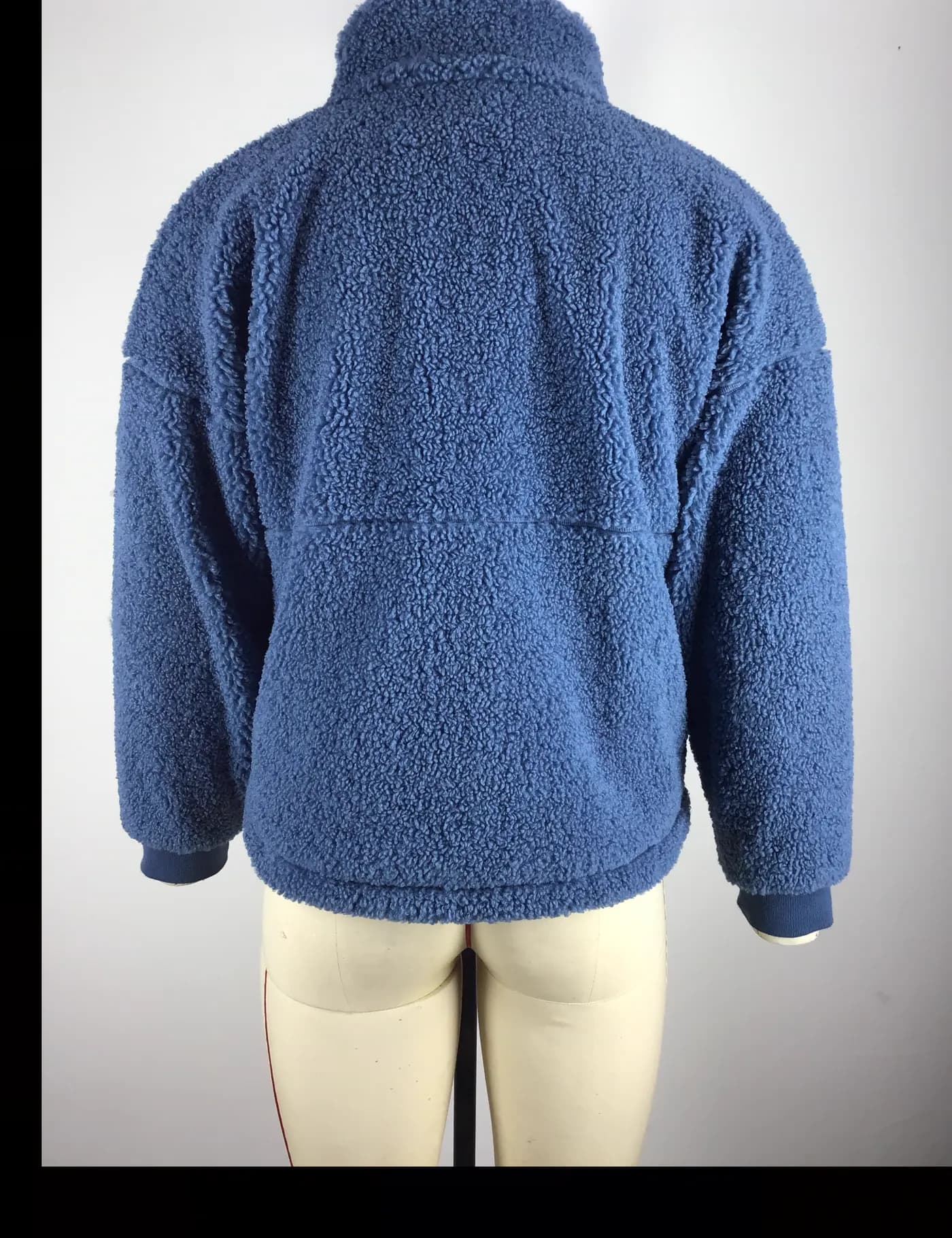 Actual blue sherpa fleece jacket sample shown from the back on a mannequin