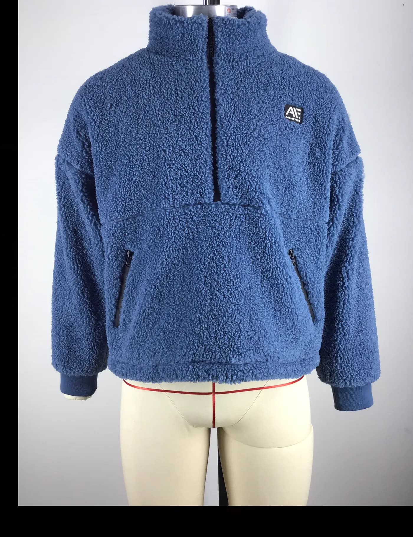 Actual blue sherpa fleece jacket sample shown from the front on a mannequin