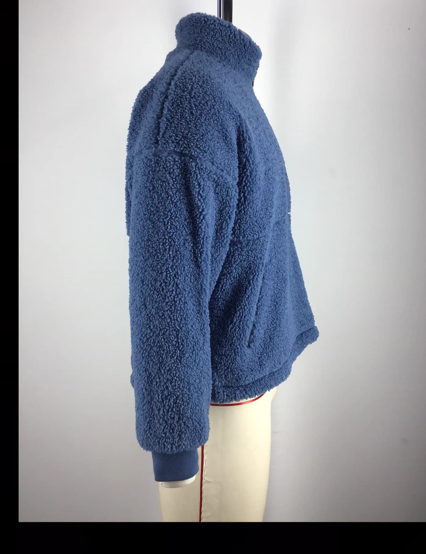 Actual blue sherpa fleece jacket sample shown from the side on a mannequin
