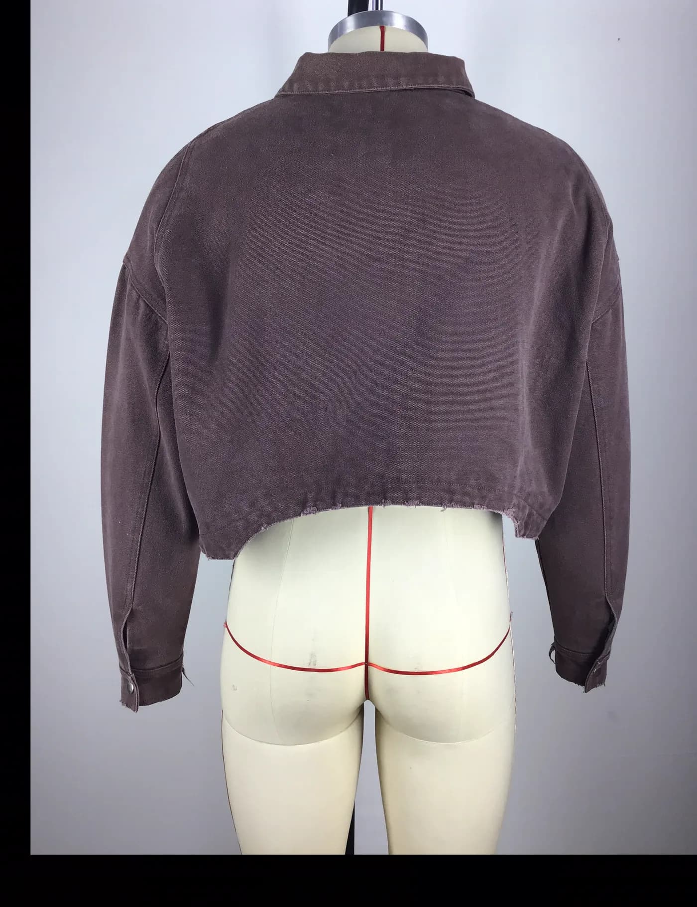 Actual brown cropped graphic workwear jacket sample shown from the back on a mannequin