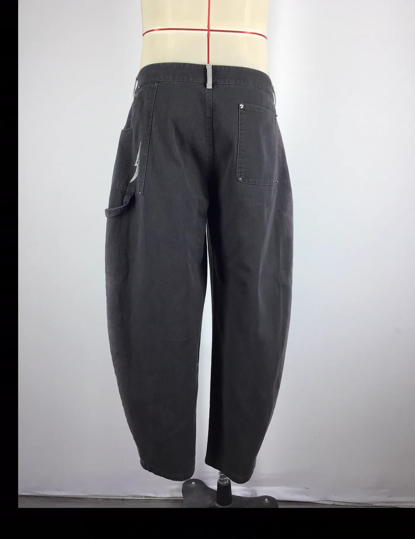 Actual charcoal washed workwear pants sample shown from the back on a mannequin