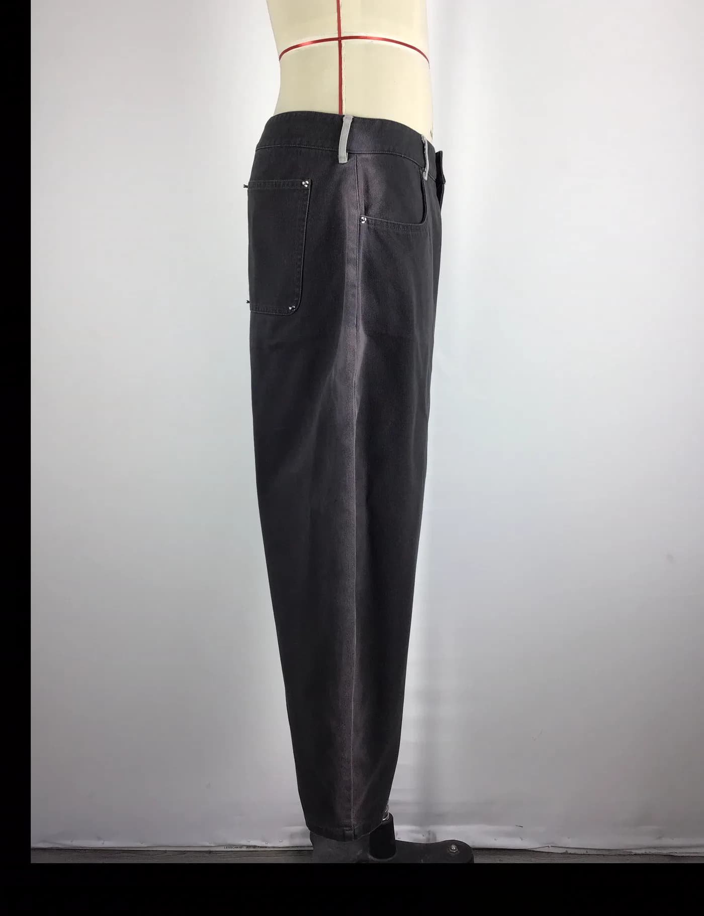 Actual charcoal washed workwear pants sample shown from the side on a mannequin