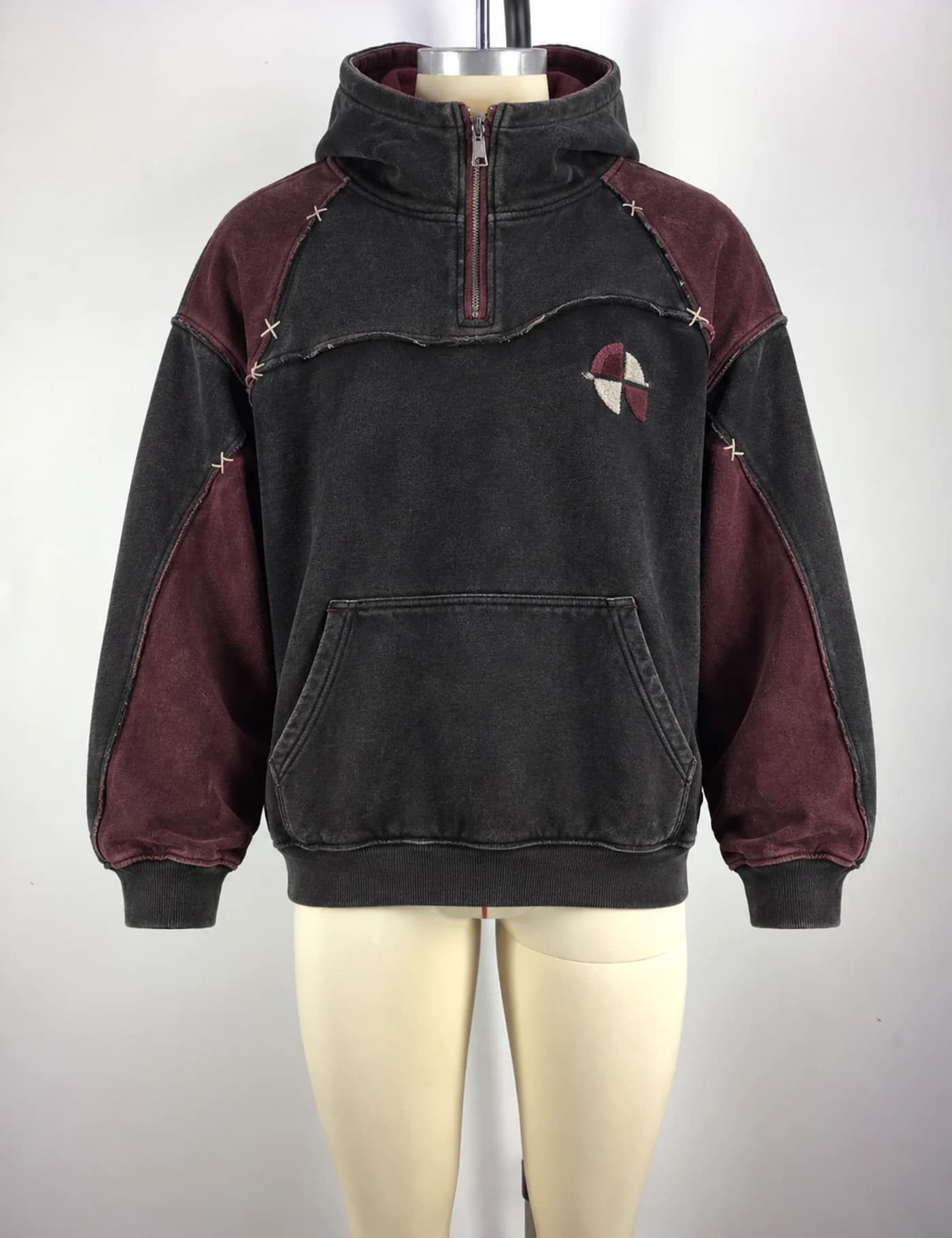 Actual color-block quarter-zip hoodie sample shown from the front on a mannequin