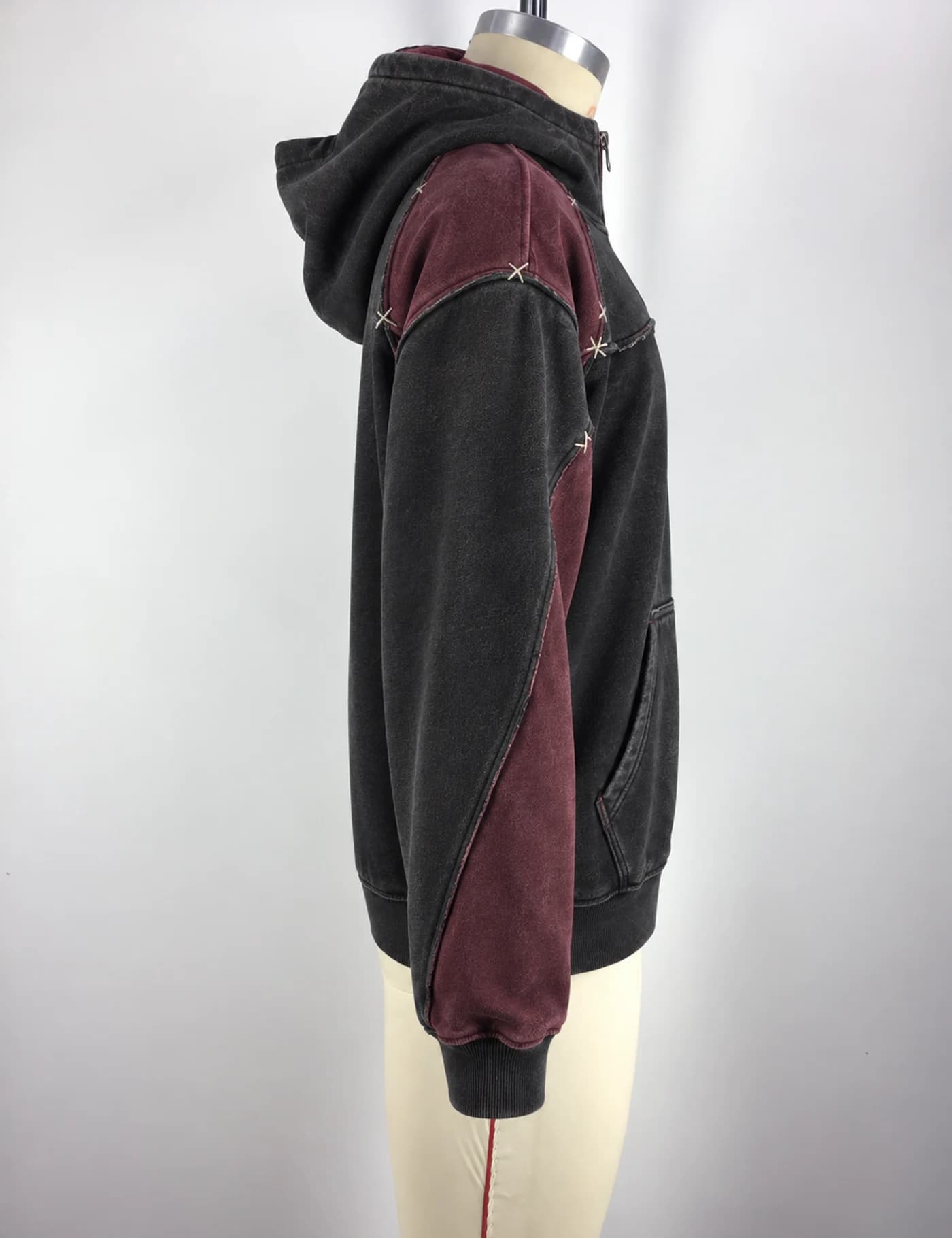 Actual color-block quarter-zip hoodie sample shown from the side on a mannequin