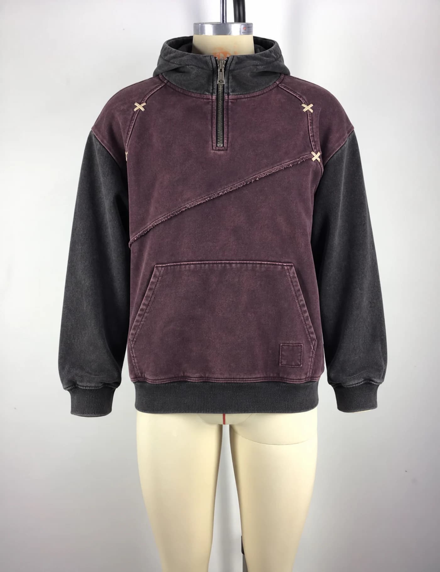 Actual color-block quarter-zip pullover hoodie sample shown from the front on a mannequin
