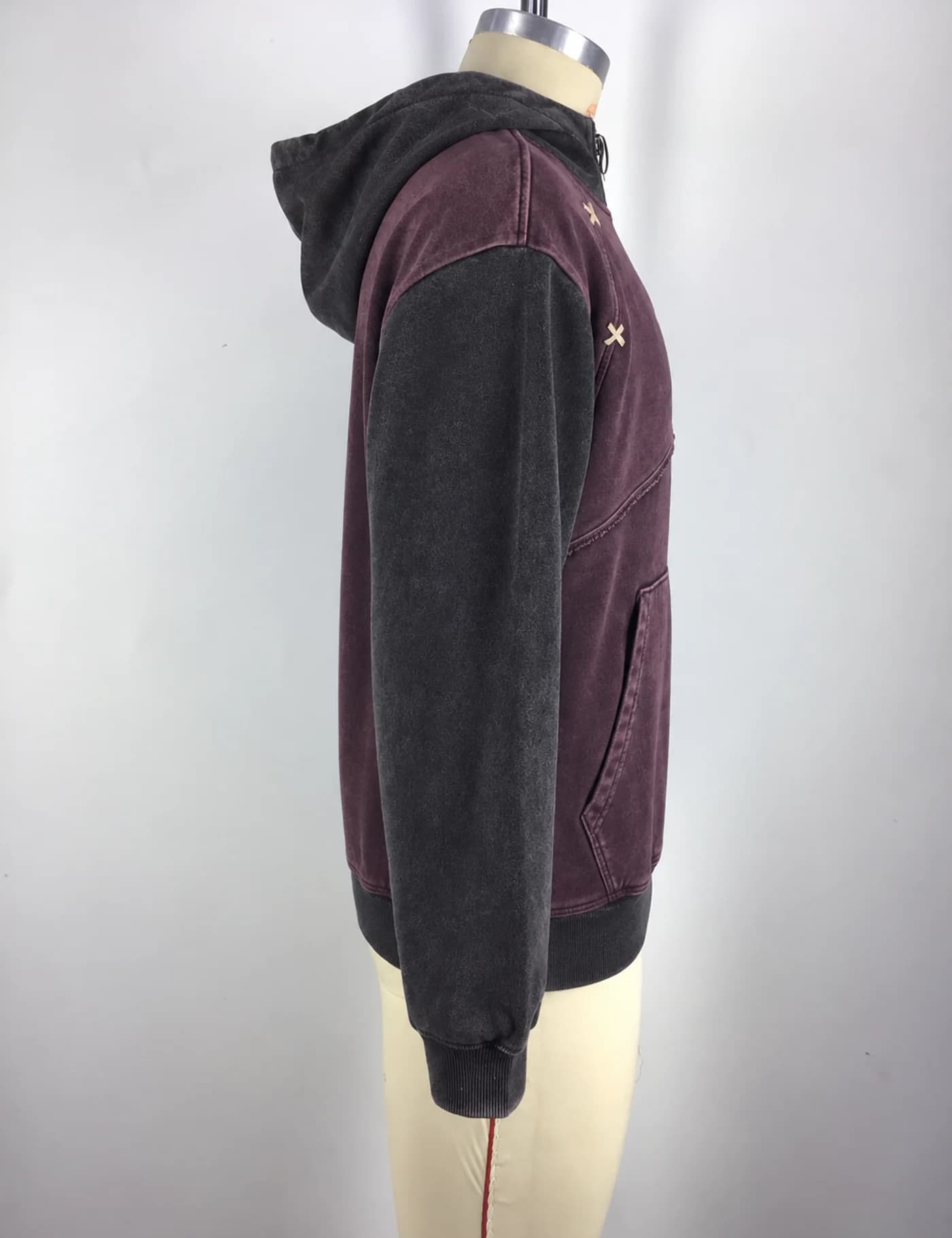 Actual color-block quarter-zip pullover hoodie sample shown from the side on a mannequin