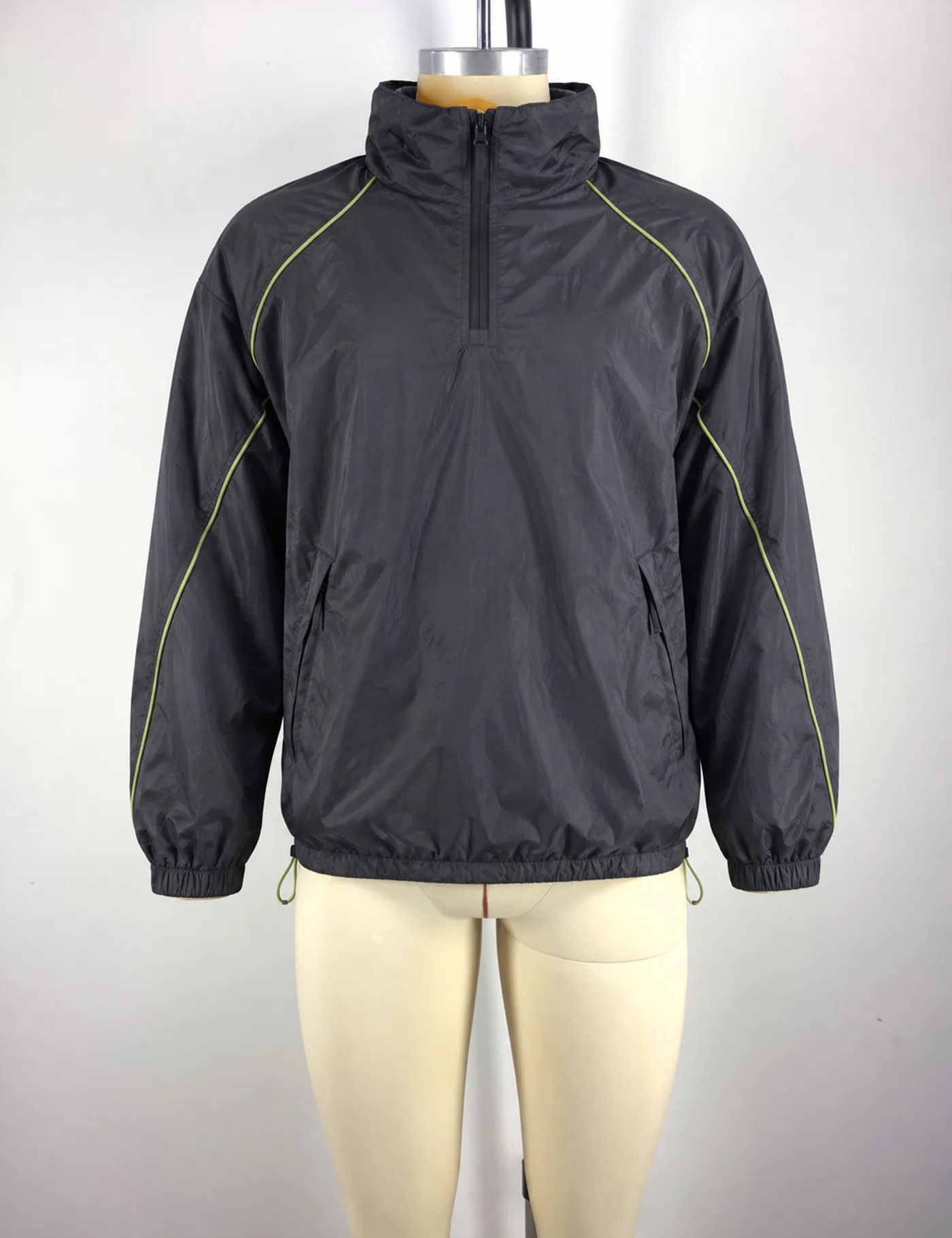 Actual contrast-piping half-zip windbreaker sample shown from the front on a mannequin