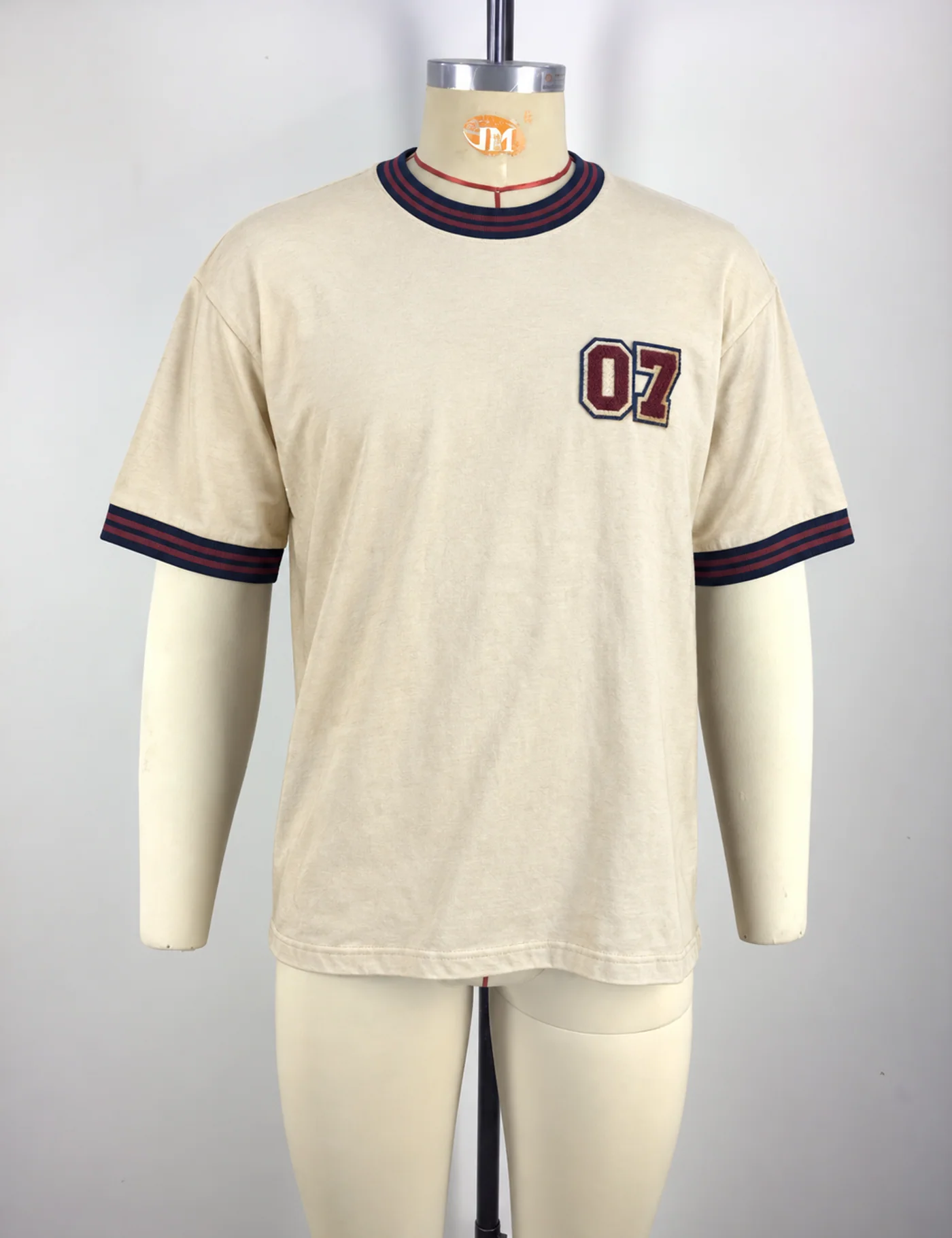 Actual chenille embroidery ringer t-shirt sample shown from the front on a mannequin
