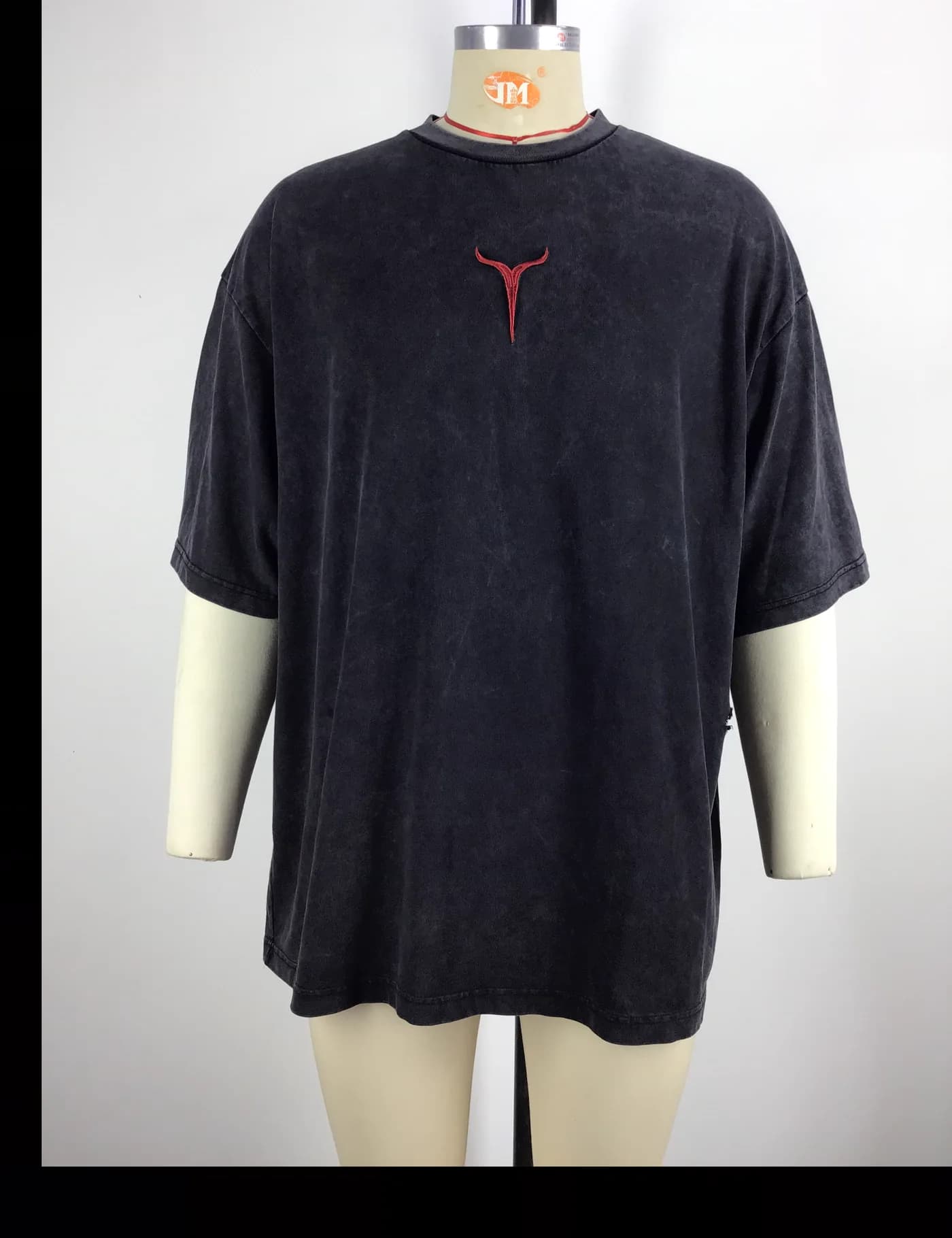 Actual embroidered oversized t-shirt sample shown from the front on a mannequin