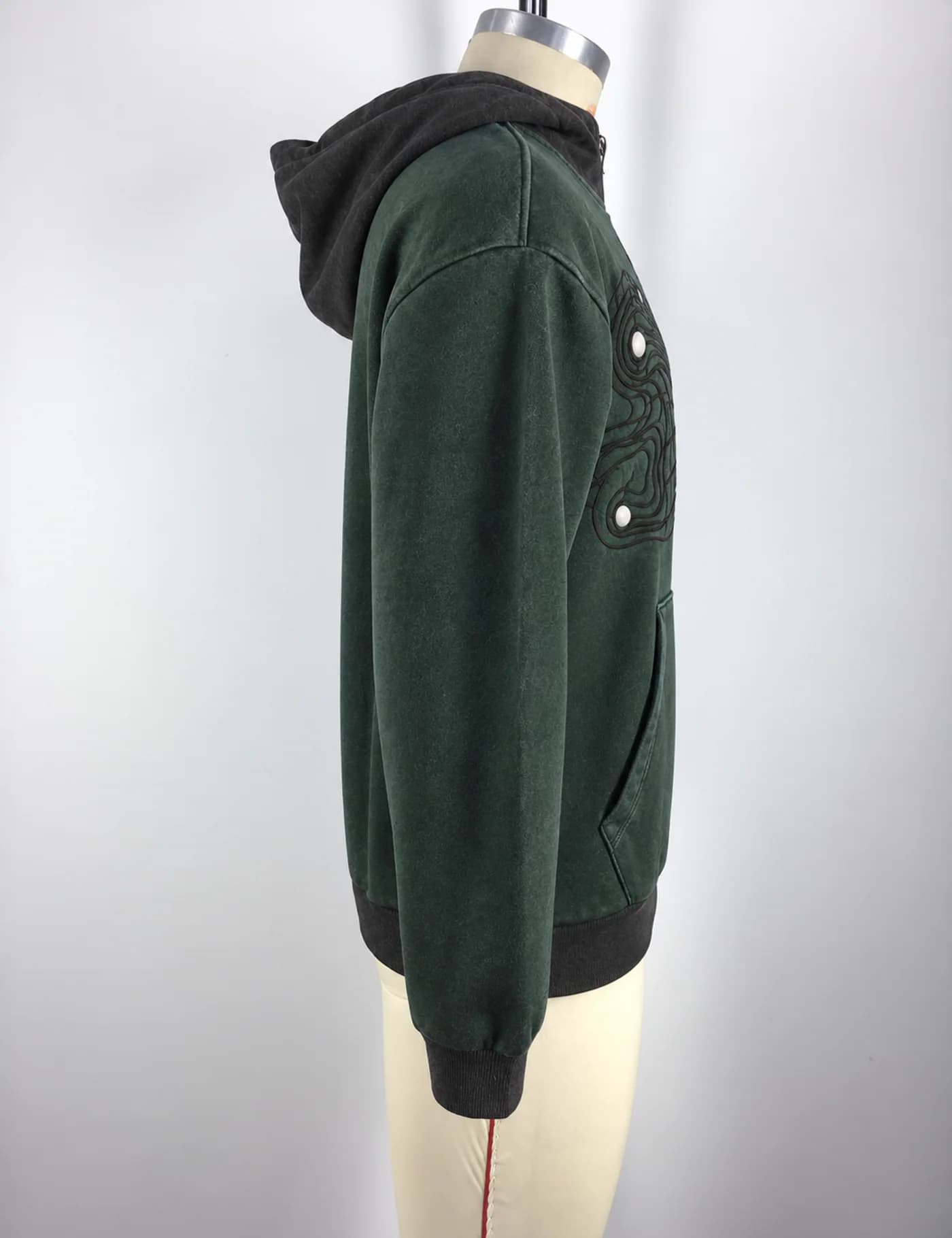 Actual hooded quarter-zip sweatshirt sample shown from the side on a mannequin