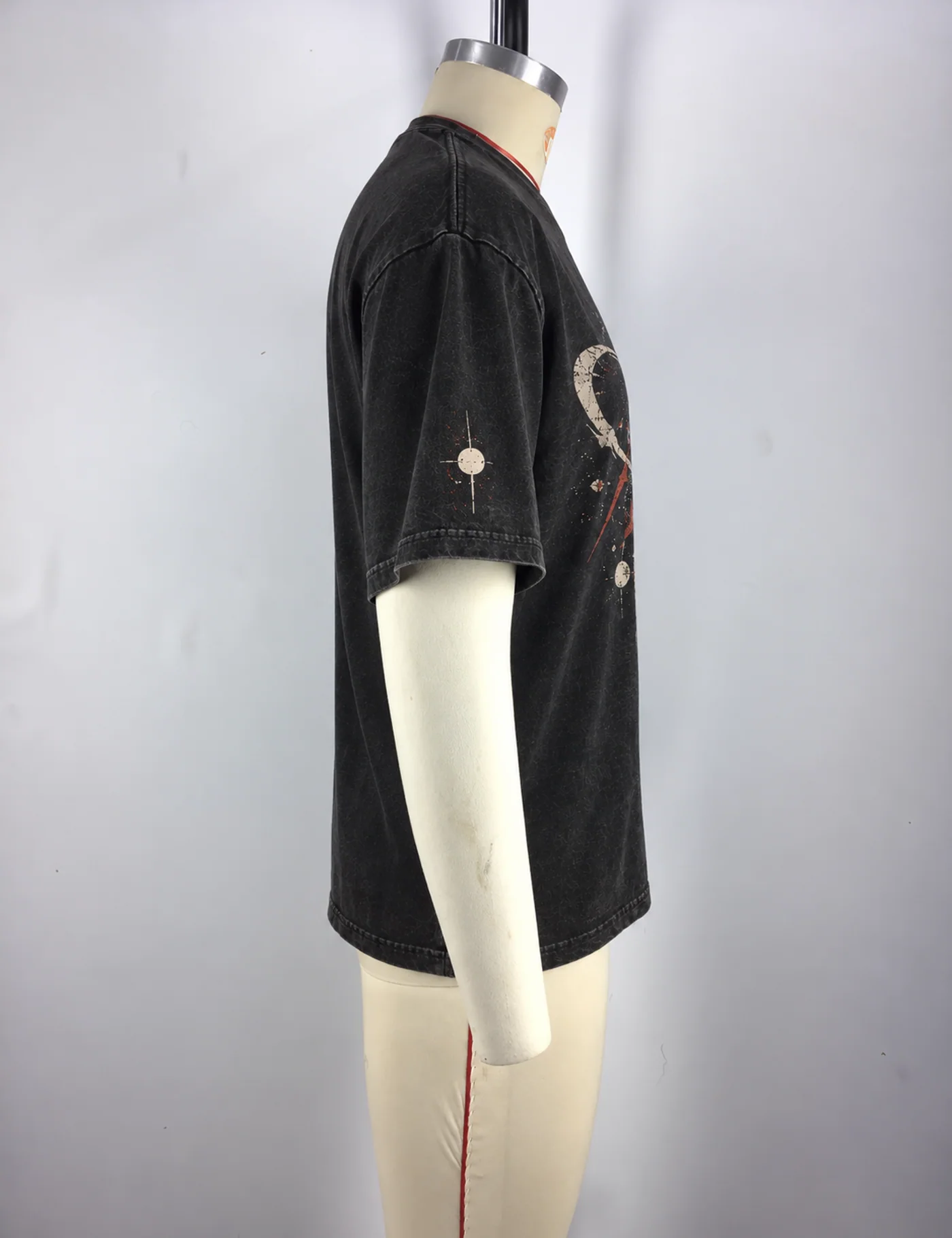 Actual oversized cracked graphic t-shirt sample shown from the side on a mannequin
