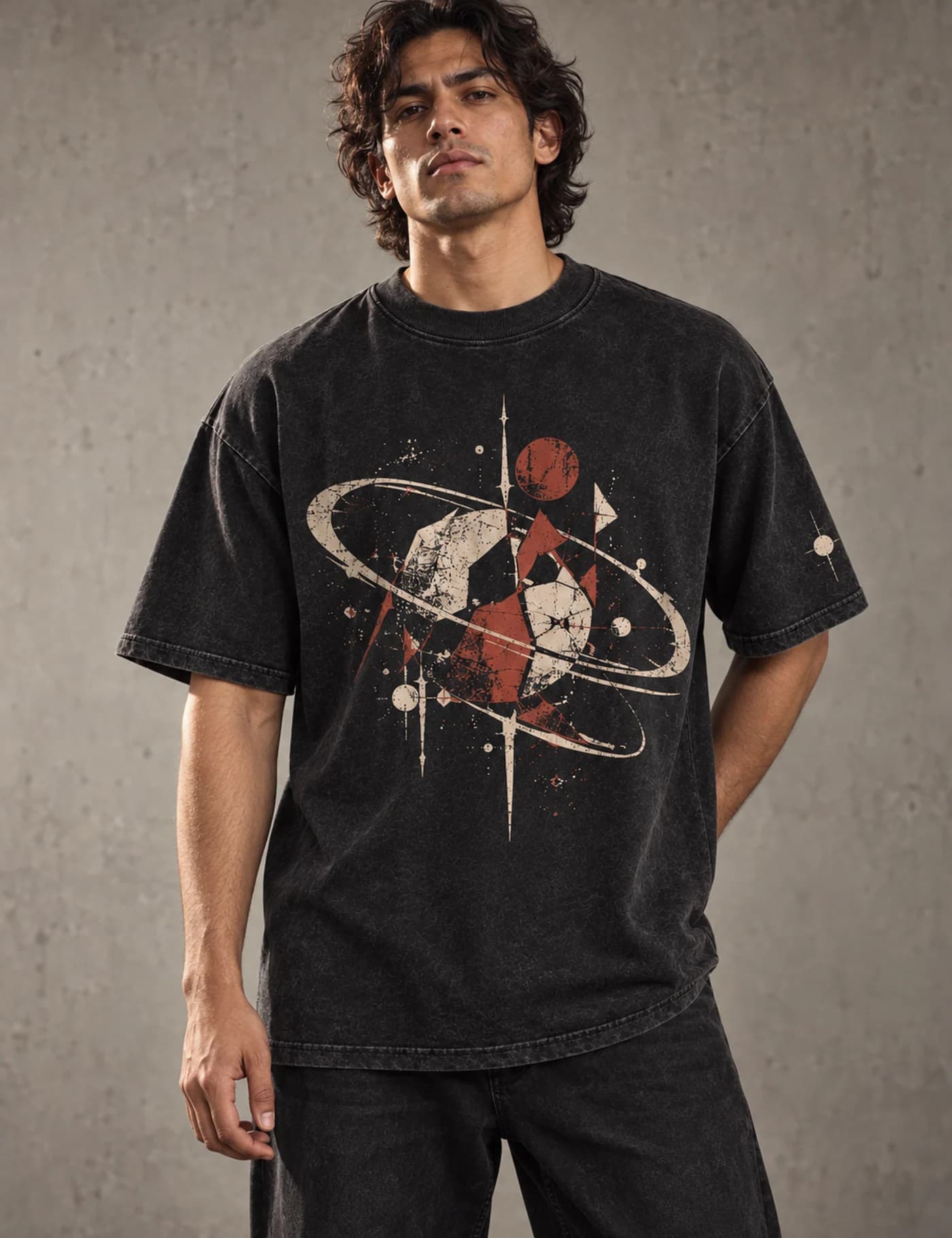 Male model wearing a washed black oversized T-shirt with a large cracked space graphic