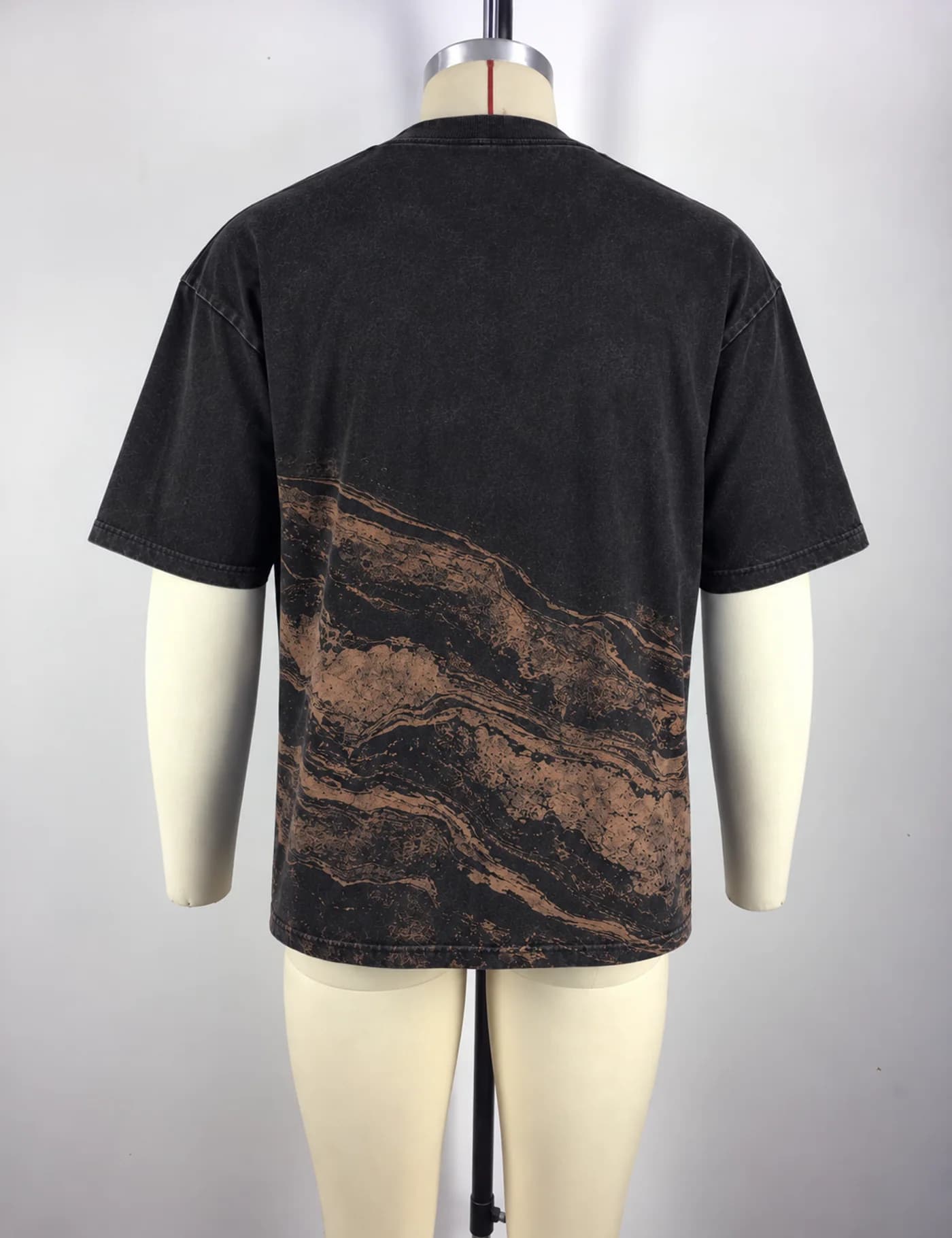Actual washed placement graphic t-shirt sample shown from the back on a mannequin
