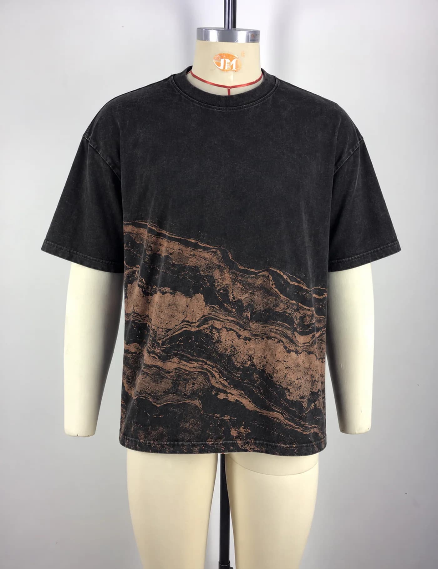 Actual washed placement graphic t-shirt sample shown from the front on a mannequin