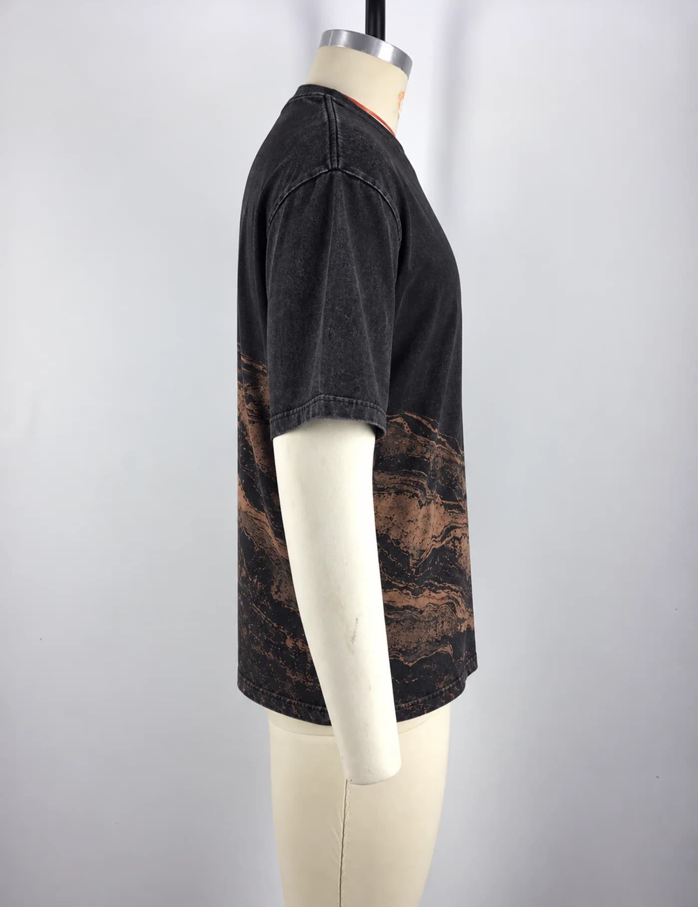 Actual washed placement graphic t-shirt sample shown from the side on a mannequin
