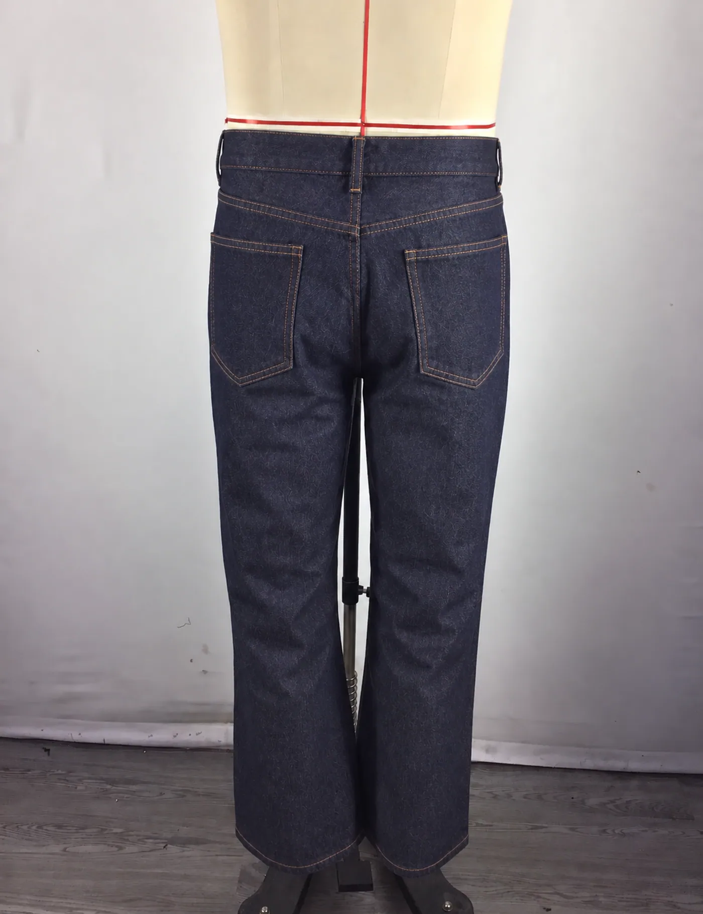 Actual dark indigo straight-leg jeans sample shown from the back on a mannequin