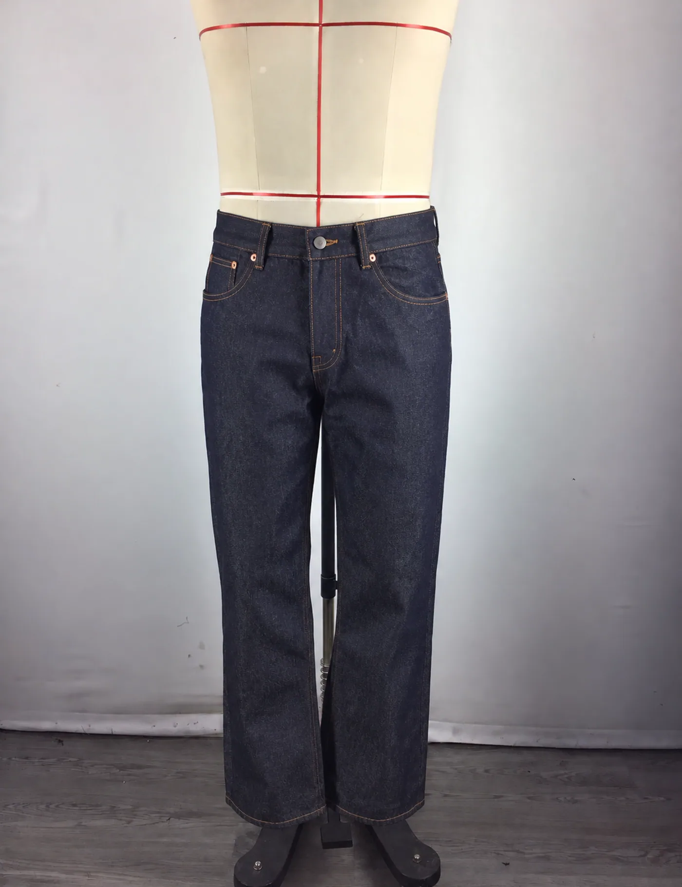 Actual dark indigo straight-leg jeans sample shown from the front on a mannequin