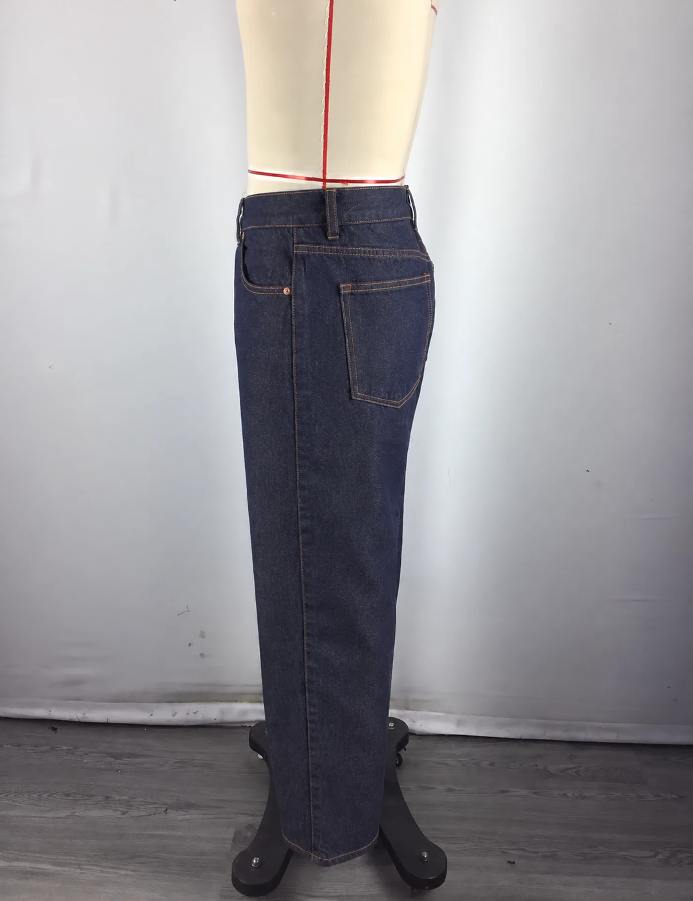 Actual dark indigo straight-leg jeans sample shown from the side on a mannequin