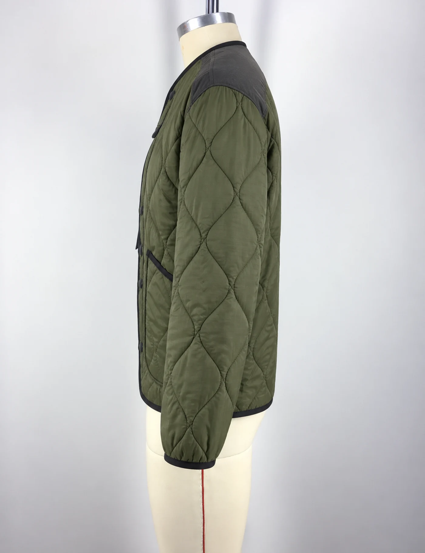 Actual diamond-quilted liner jacket sample shown from the side on a mannequin