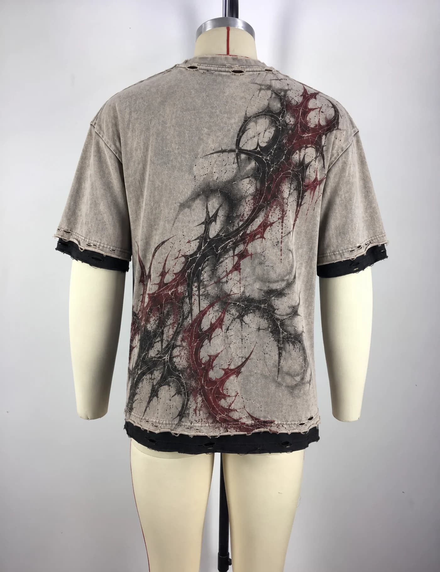 Actual distressed layered graphic t-shirt sample shown from the back on a mannequin