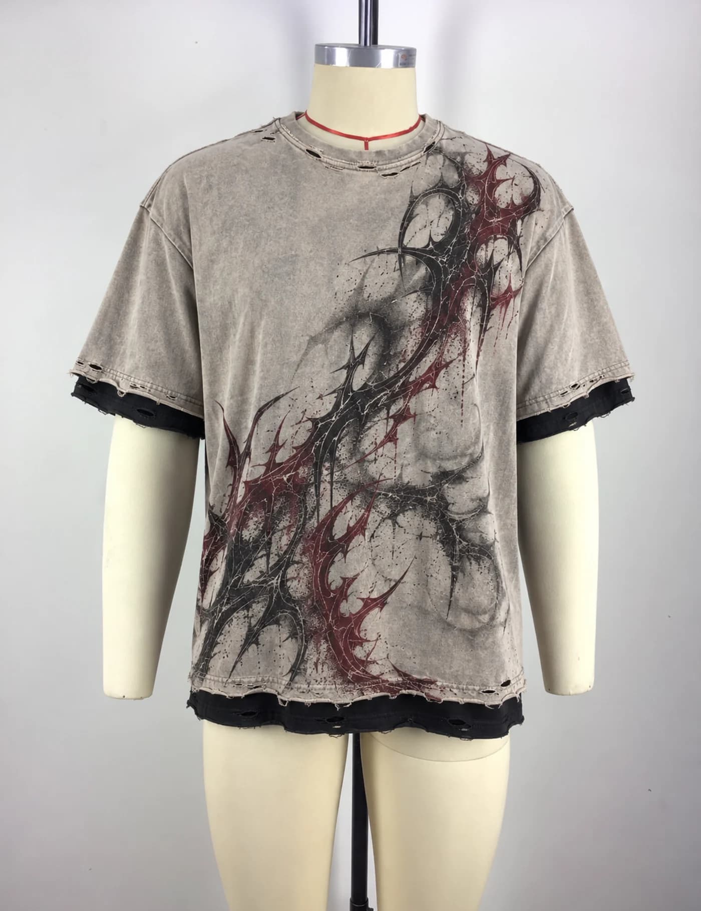 Actual distressed layered graphic t-shirt sample shown from the front on a mannequin
