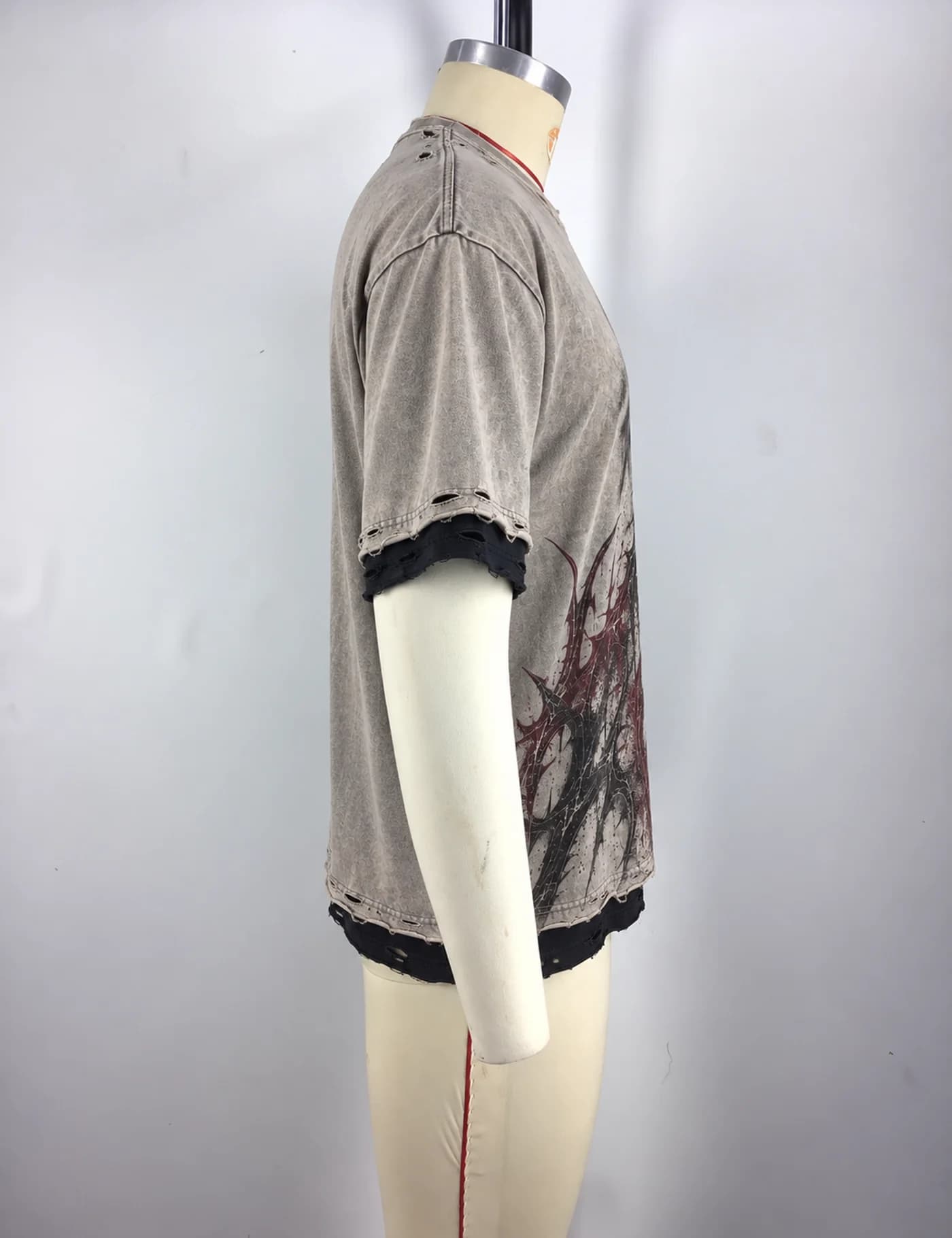 Actual distressed layered graphic t-shirt sample shown from the side on a mannequin