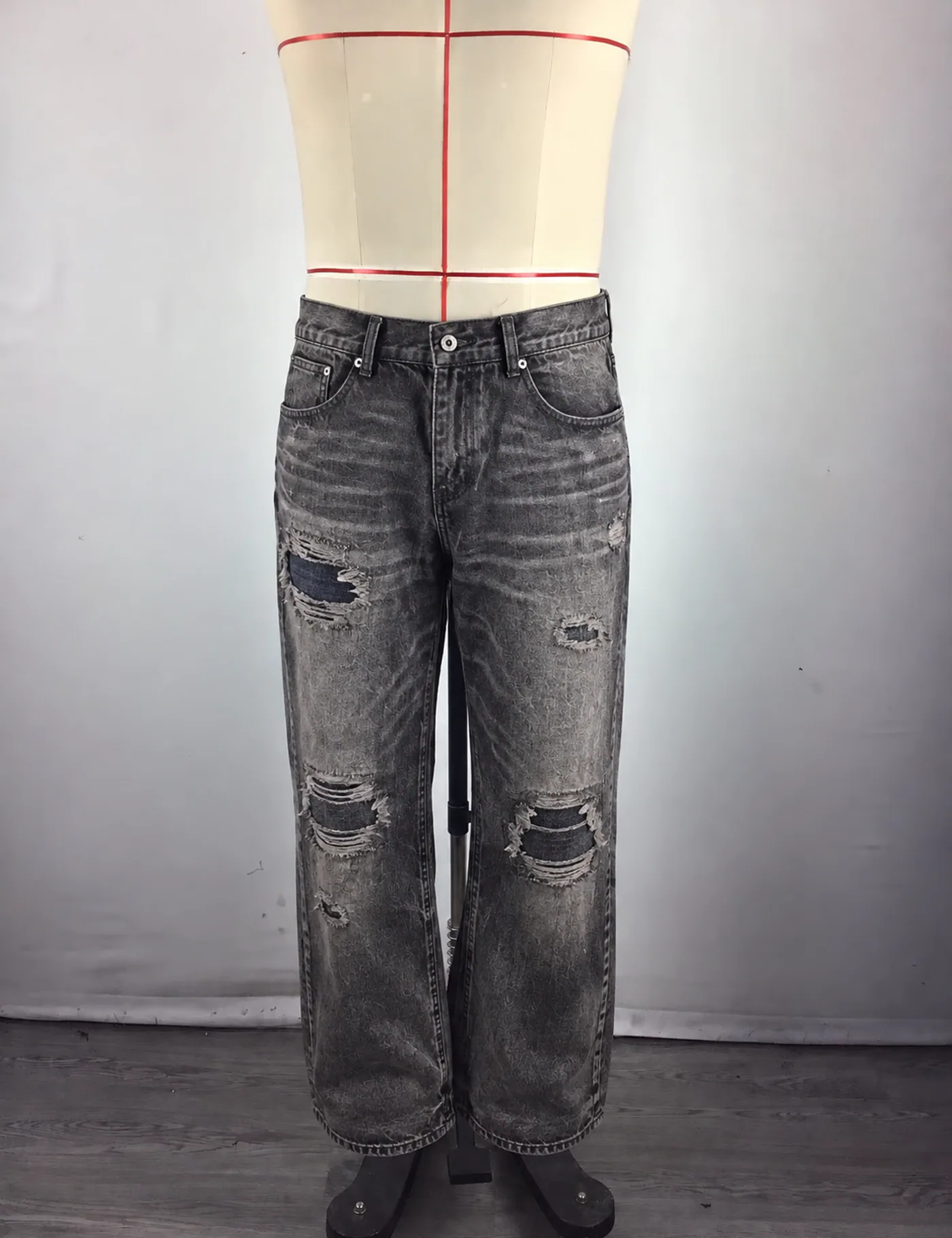 Actual distressed ripped straight-leg jeans sample shown from the front on a mannequin