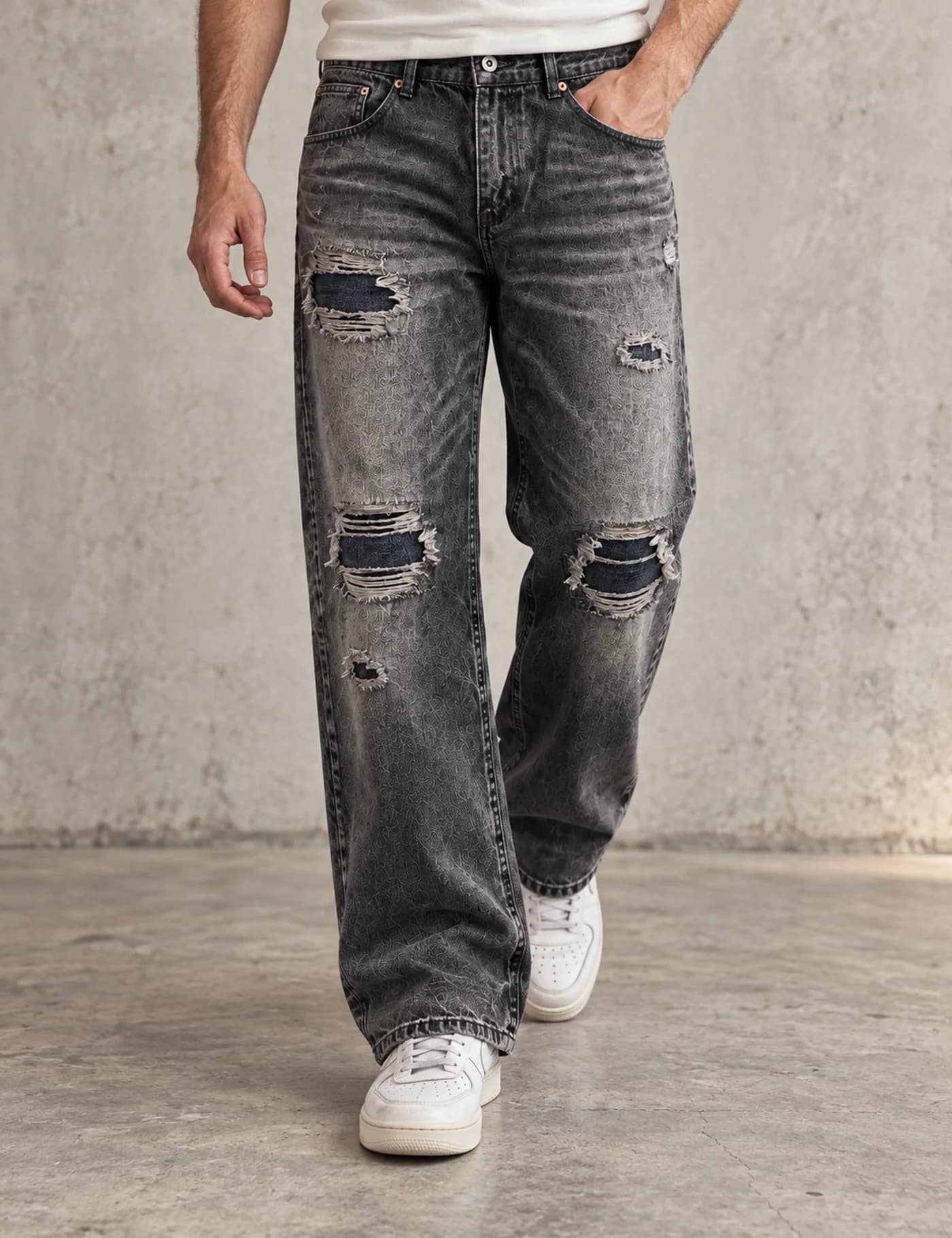 Male lower-body model wearing charcoal acid-washed straight-leg jeans with mapped rips