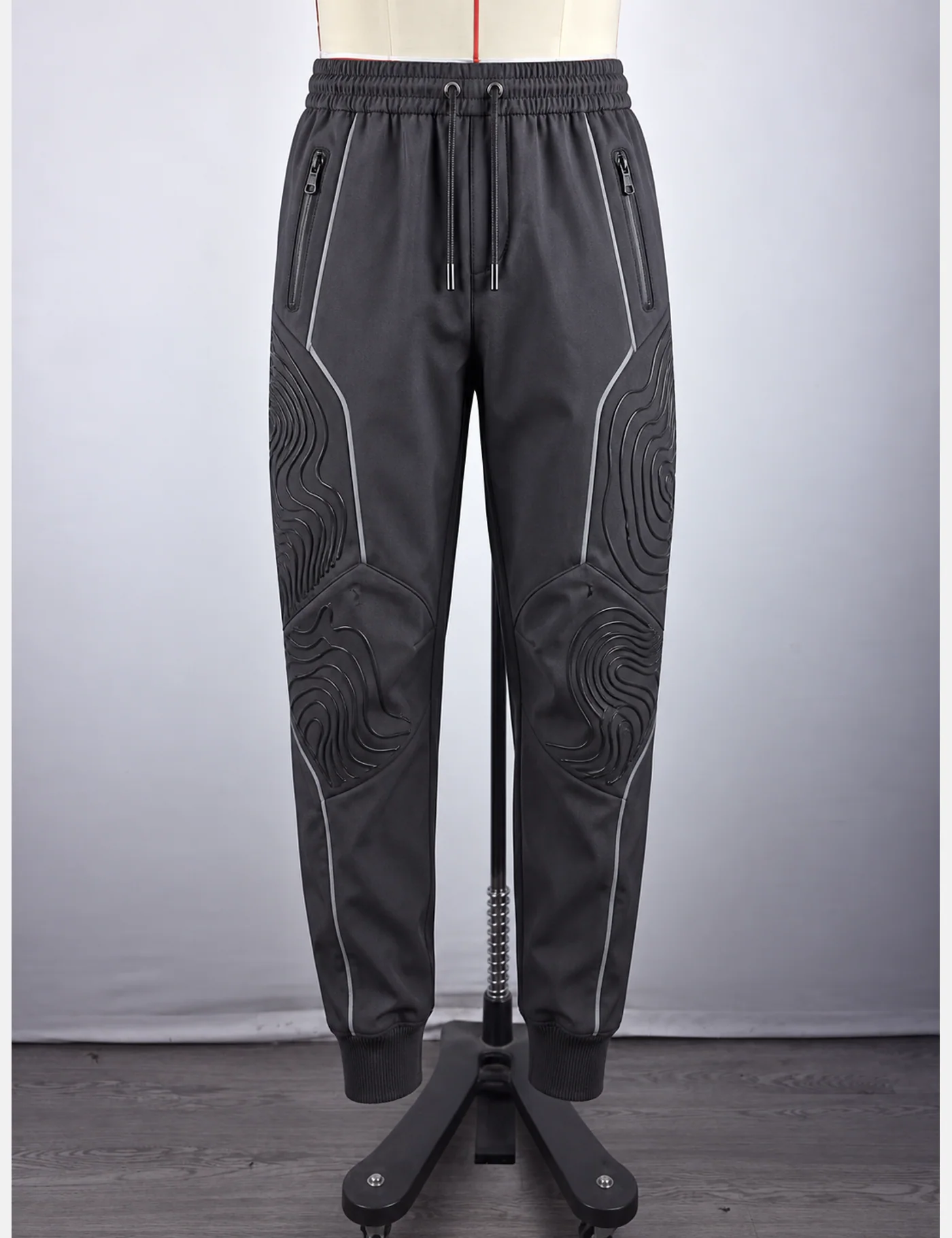 Actual embossed contour-knee technical joggers sample shown from the front on a mannequin
