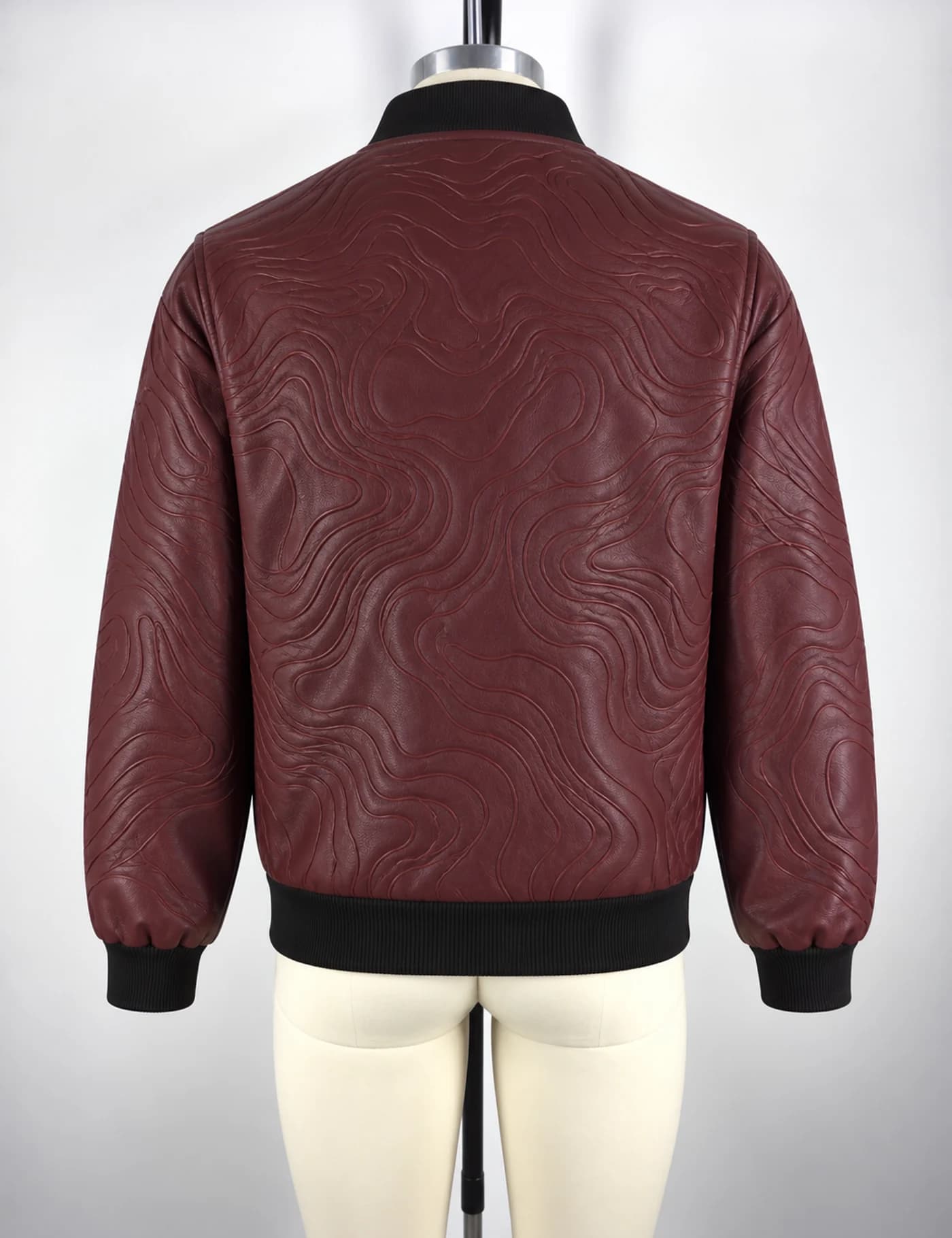 Actual embossed faux-leather bomber jacket sample shown from the back on a mannequin
