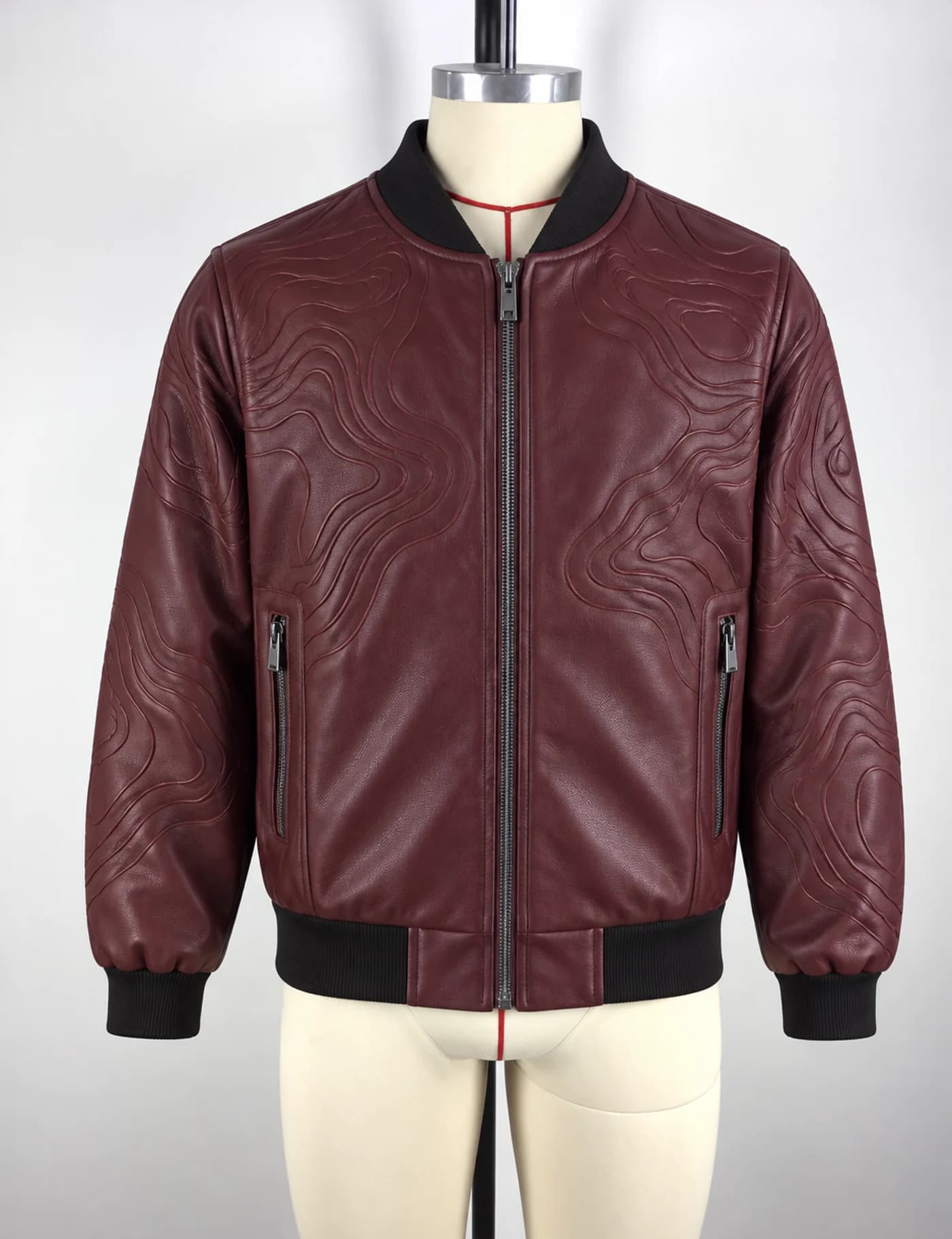 Actual embossed faux-leather bomber jacket sample shown from the front on a mannequin