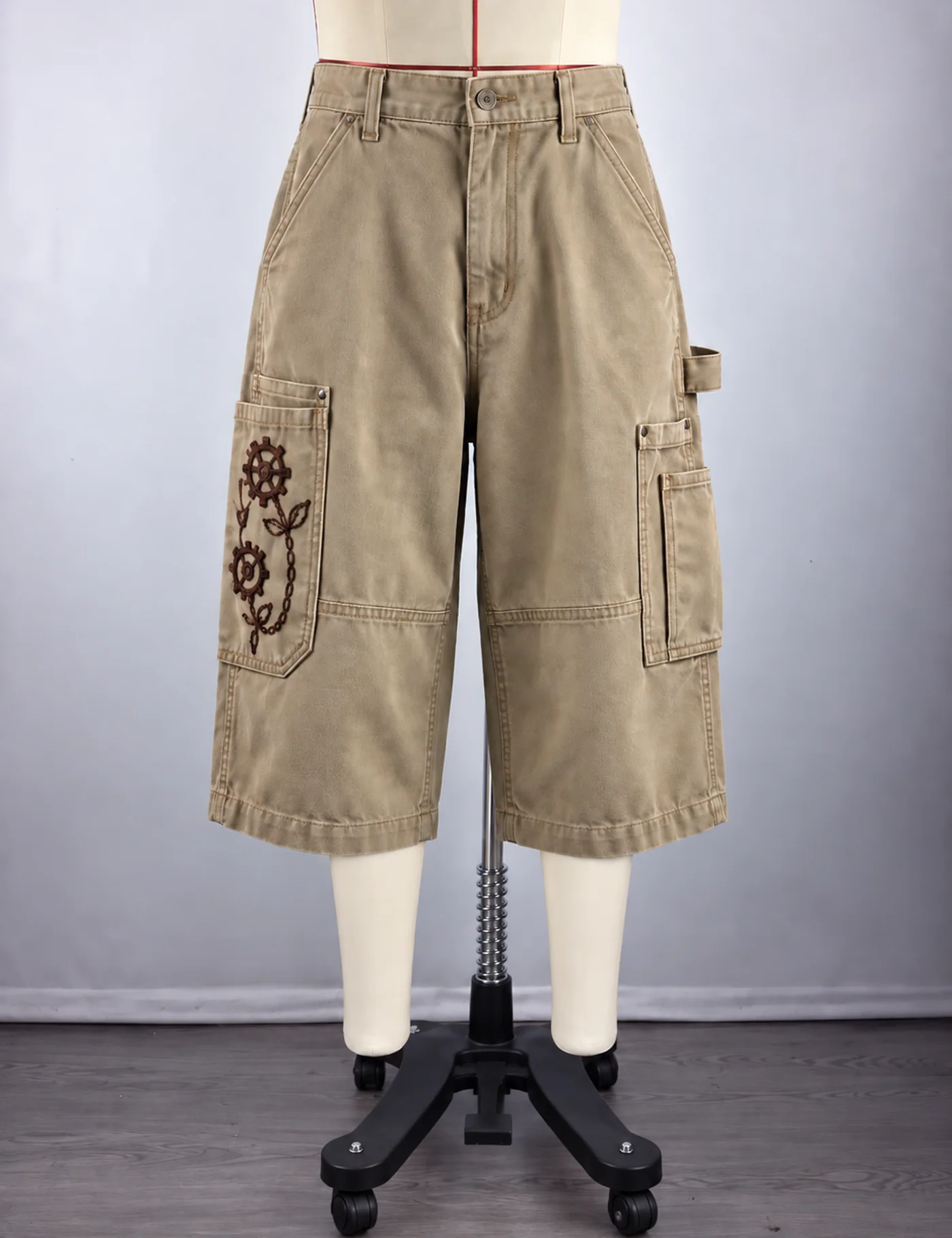 Actual embroidered utility cargo shorts sample shown from the front on a mannequin