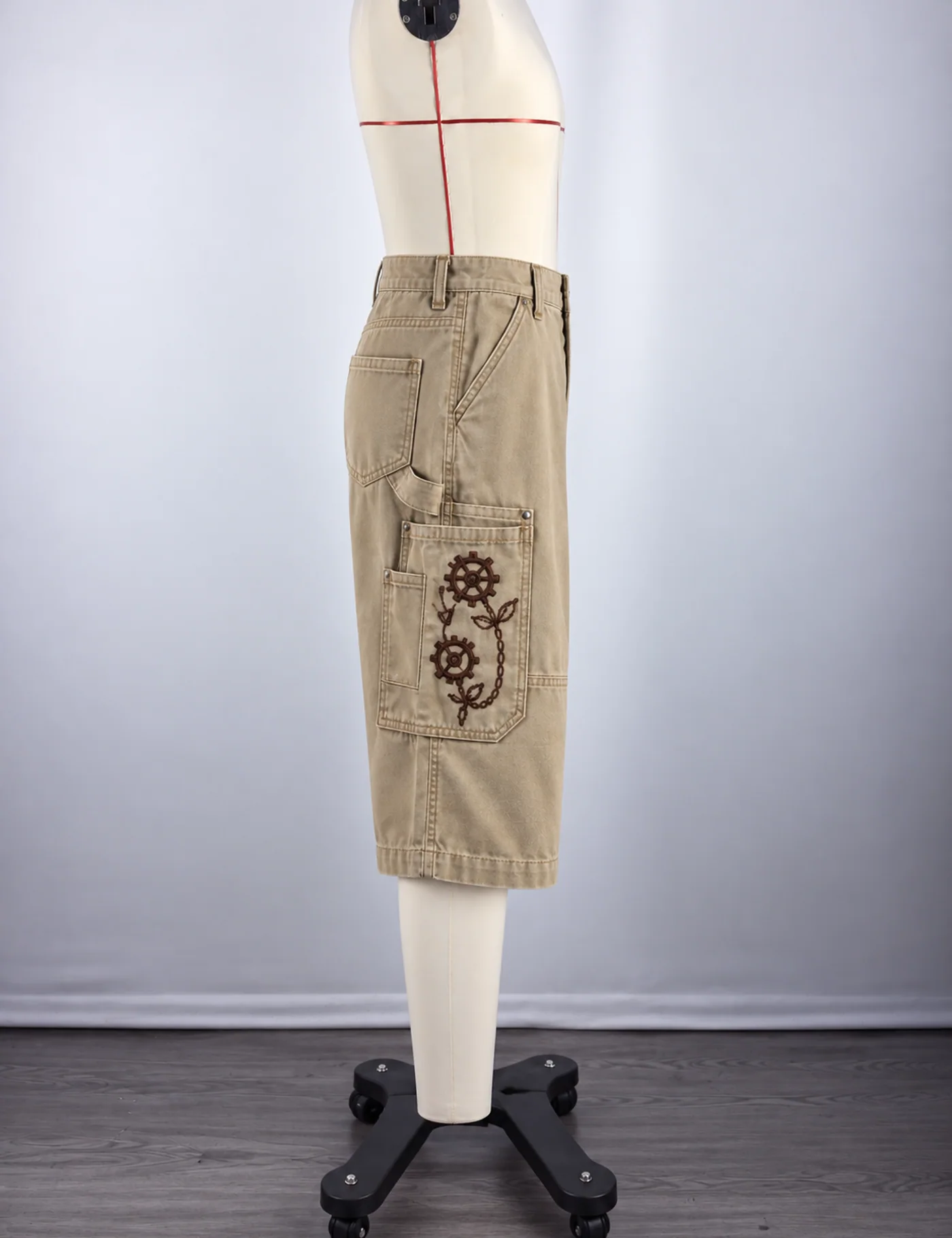 Actual embroidered utility cargo shorts sample shown from the side on a mannequin