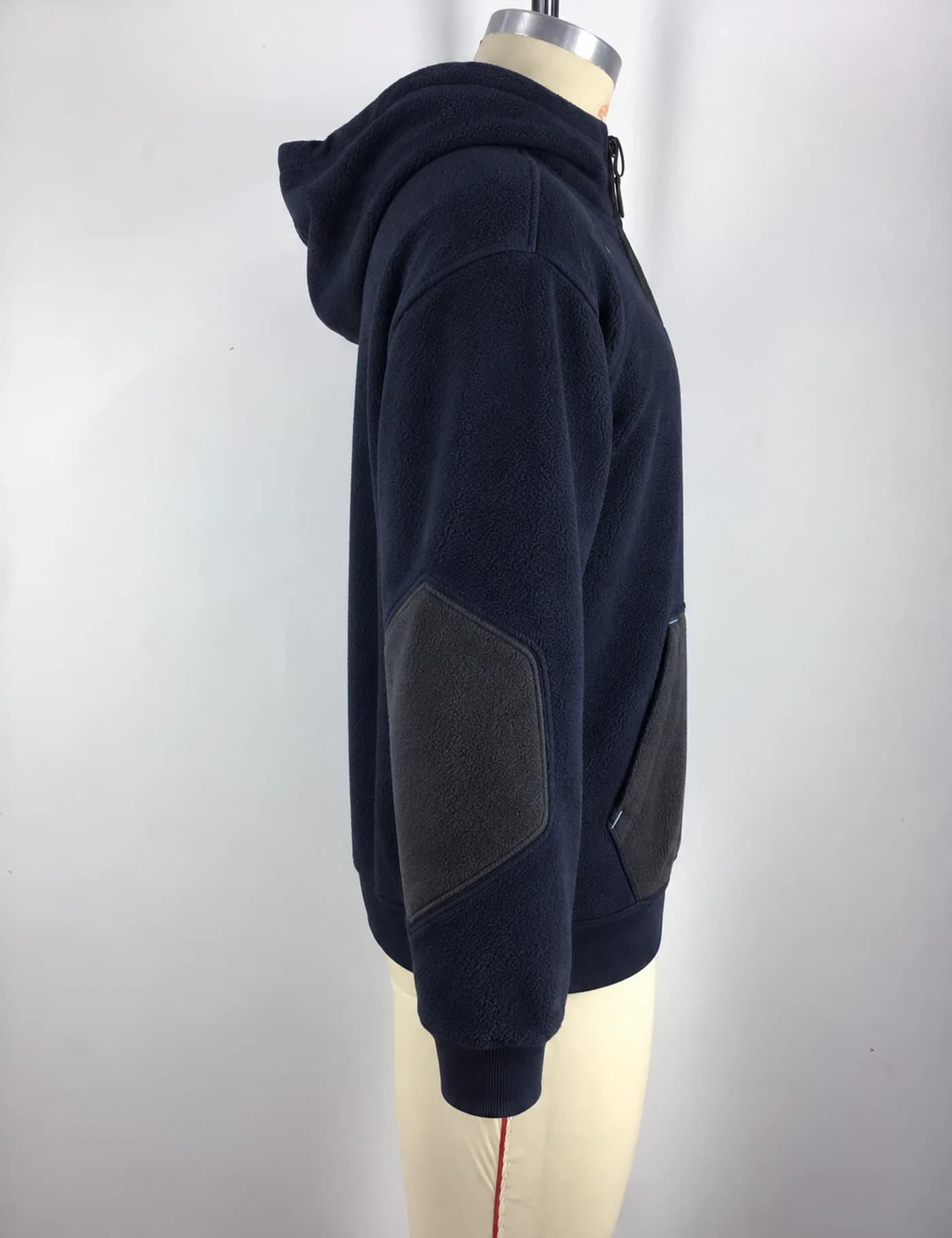 Actual fleece-panel half-zip hoodie sample shown from the side on a mannequin