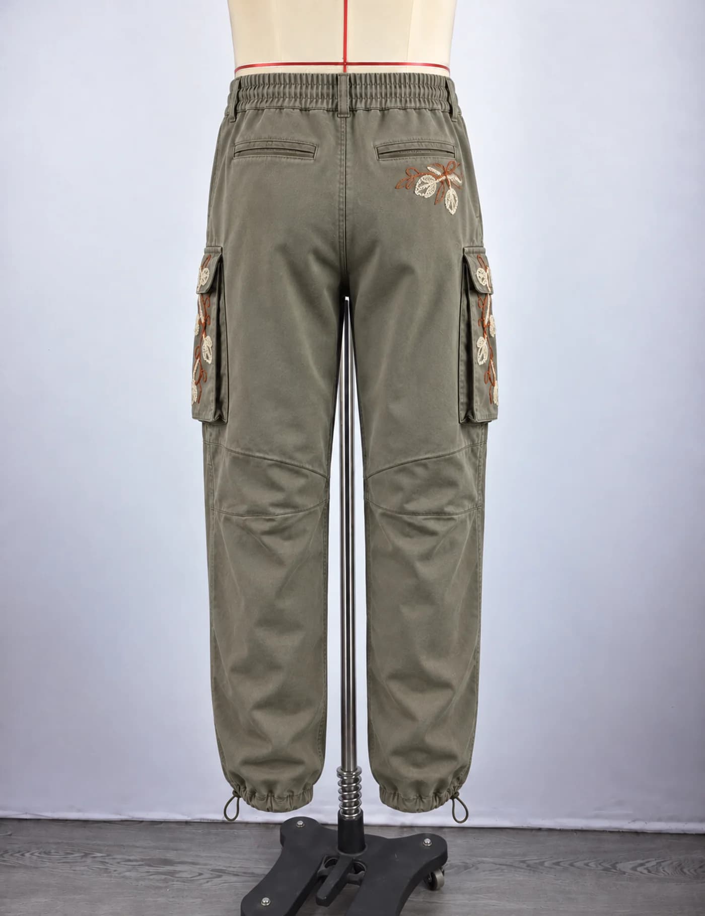 Actual floral embroidered cargo pants sample shown from the back on a mannequin