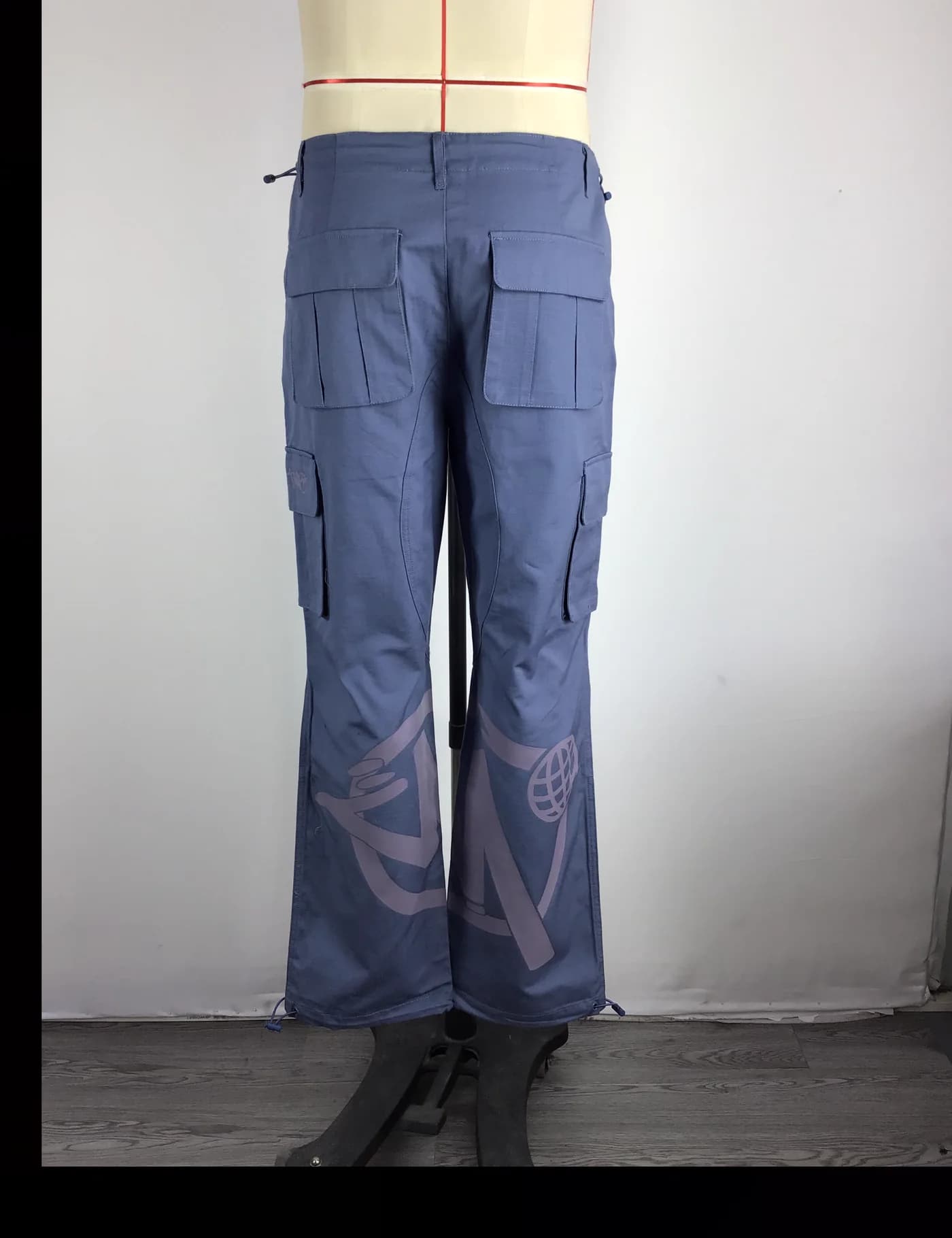 Actual graphic wide-leg cargo pants sample shown from the back on a mannequin