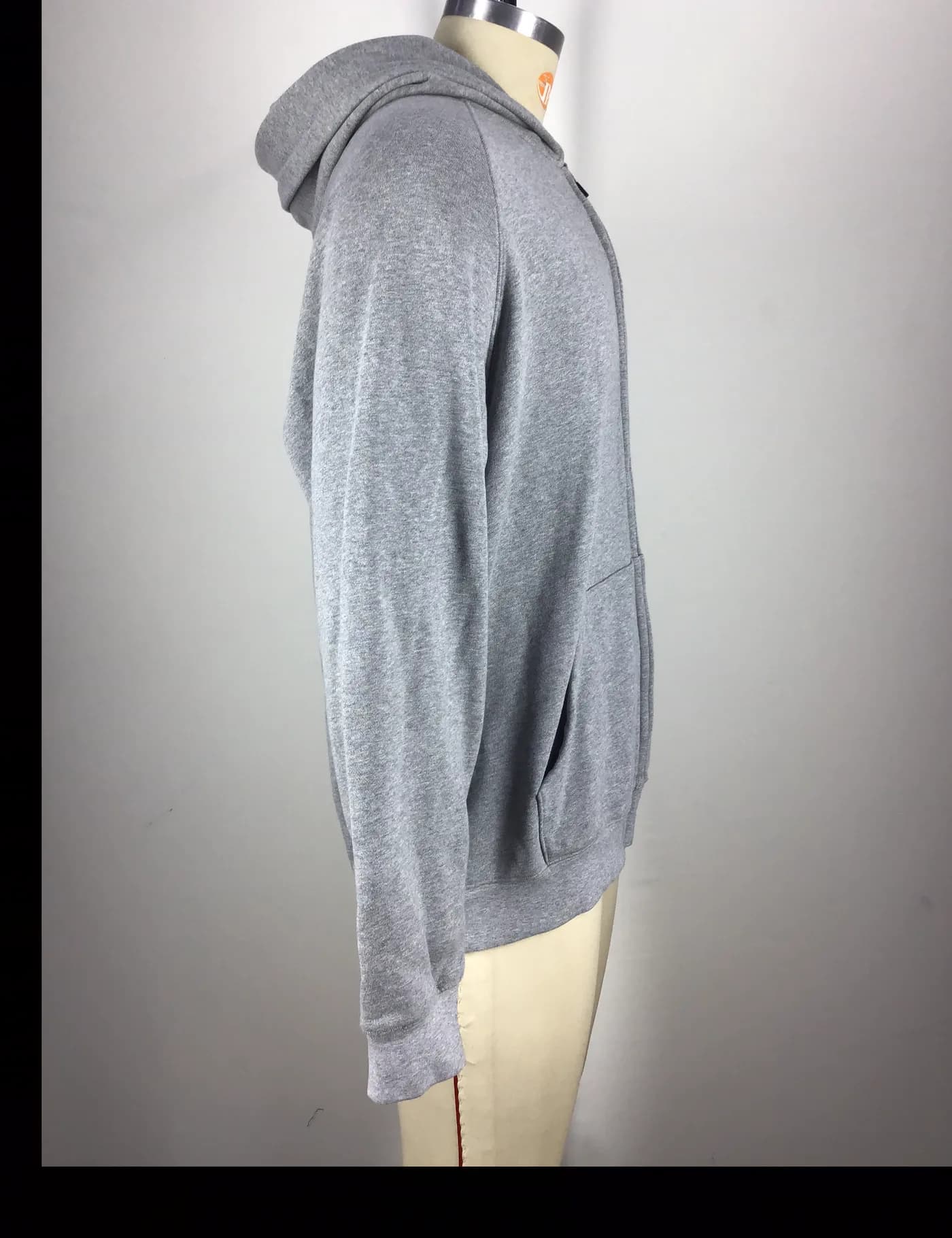 Actual gray full-zip hoodie sample shown from the side on a mannequin