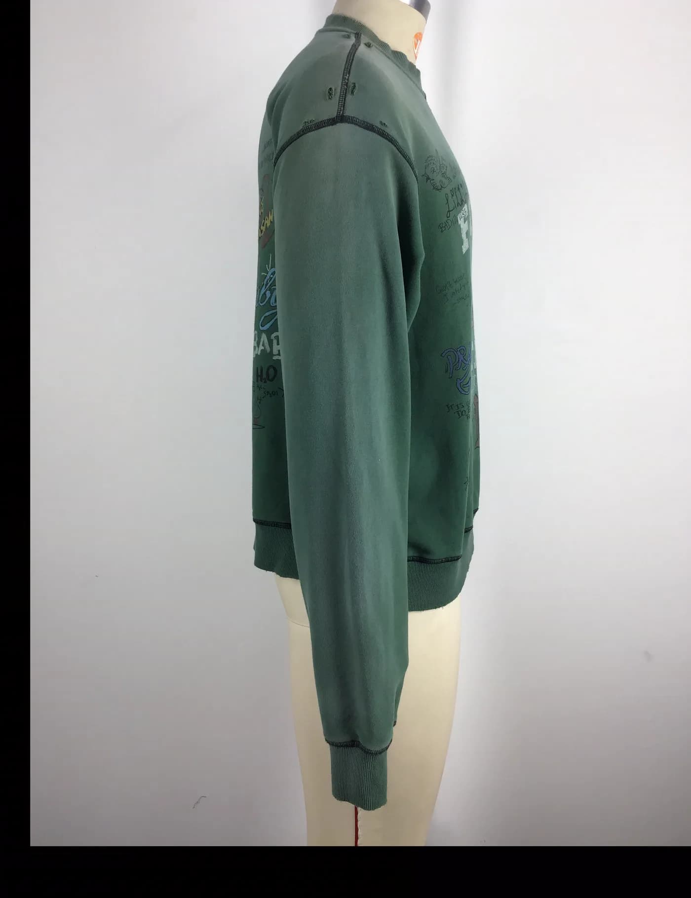 Actual green vintage washed graphic crewneck sweatshirt sample shown from the side on a mannequin