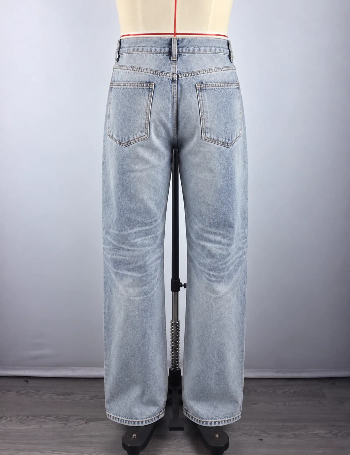 Actual light-wash extra-wide-leg jeans sample shown from the back on a mannequin