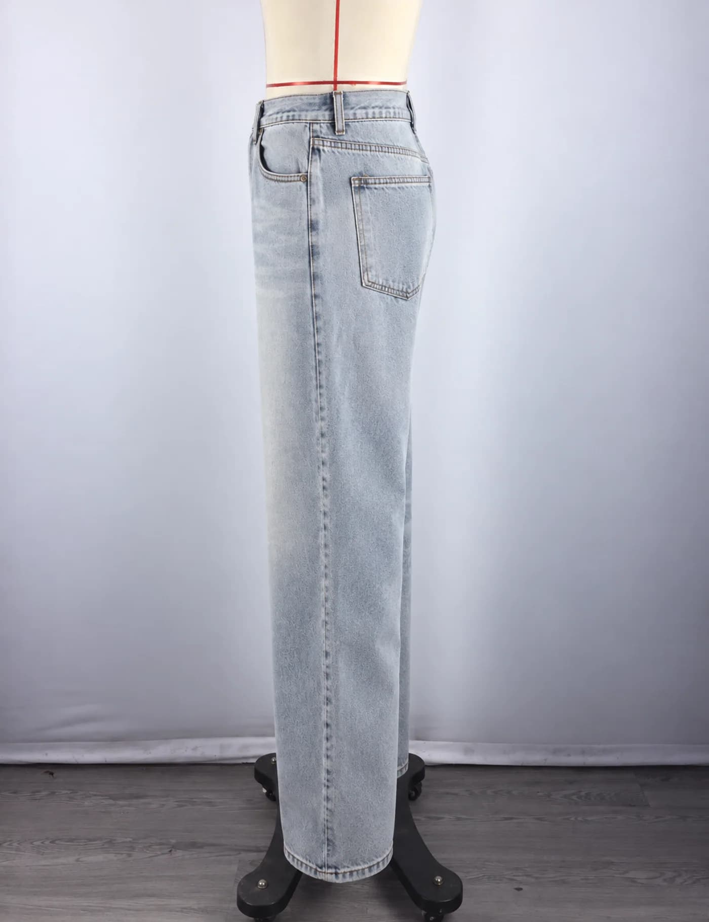 Actual light-wash extra-wide-leg jeans sample shown from the side on a mannequin