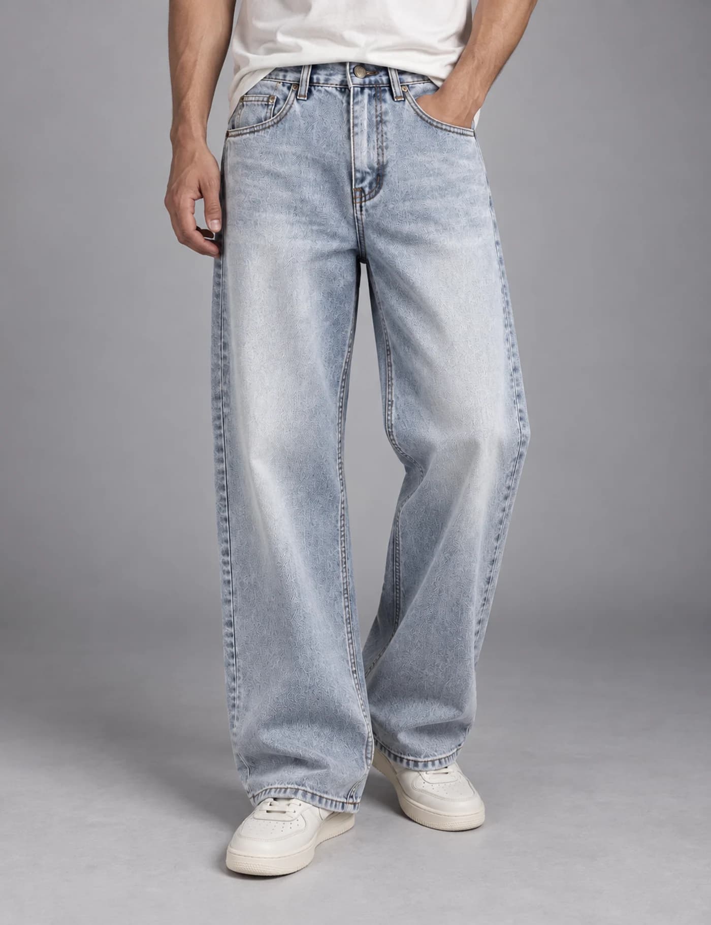 Male model wearing pale light-wash extra-wide-leg jeans with a clean five-pocket design